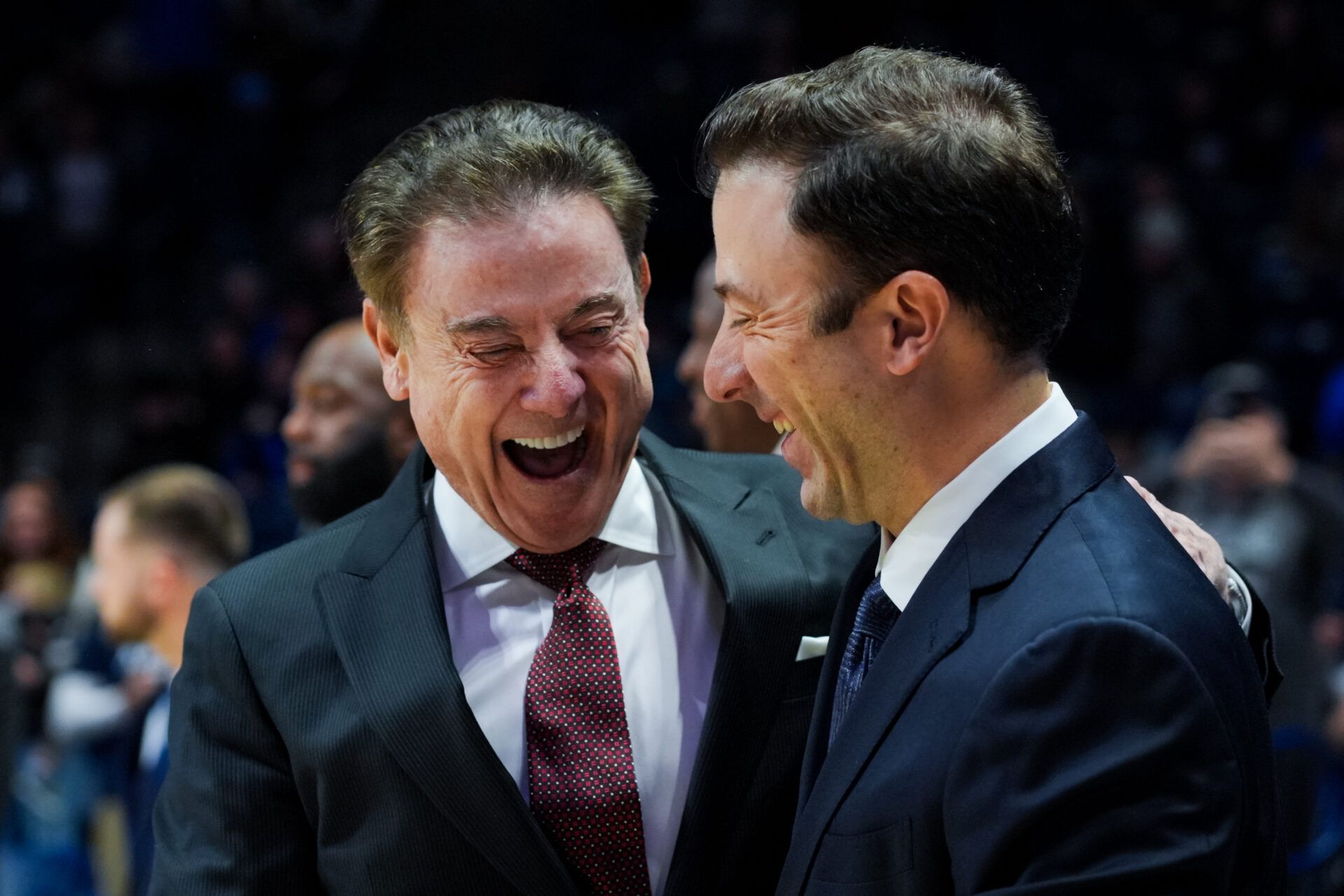 St. John's Red Storm head coach Rick Pitino, left, talks with Xavier Musketeers head coach Richard Pitino, right, before their game at the Cintas Center.