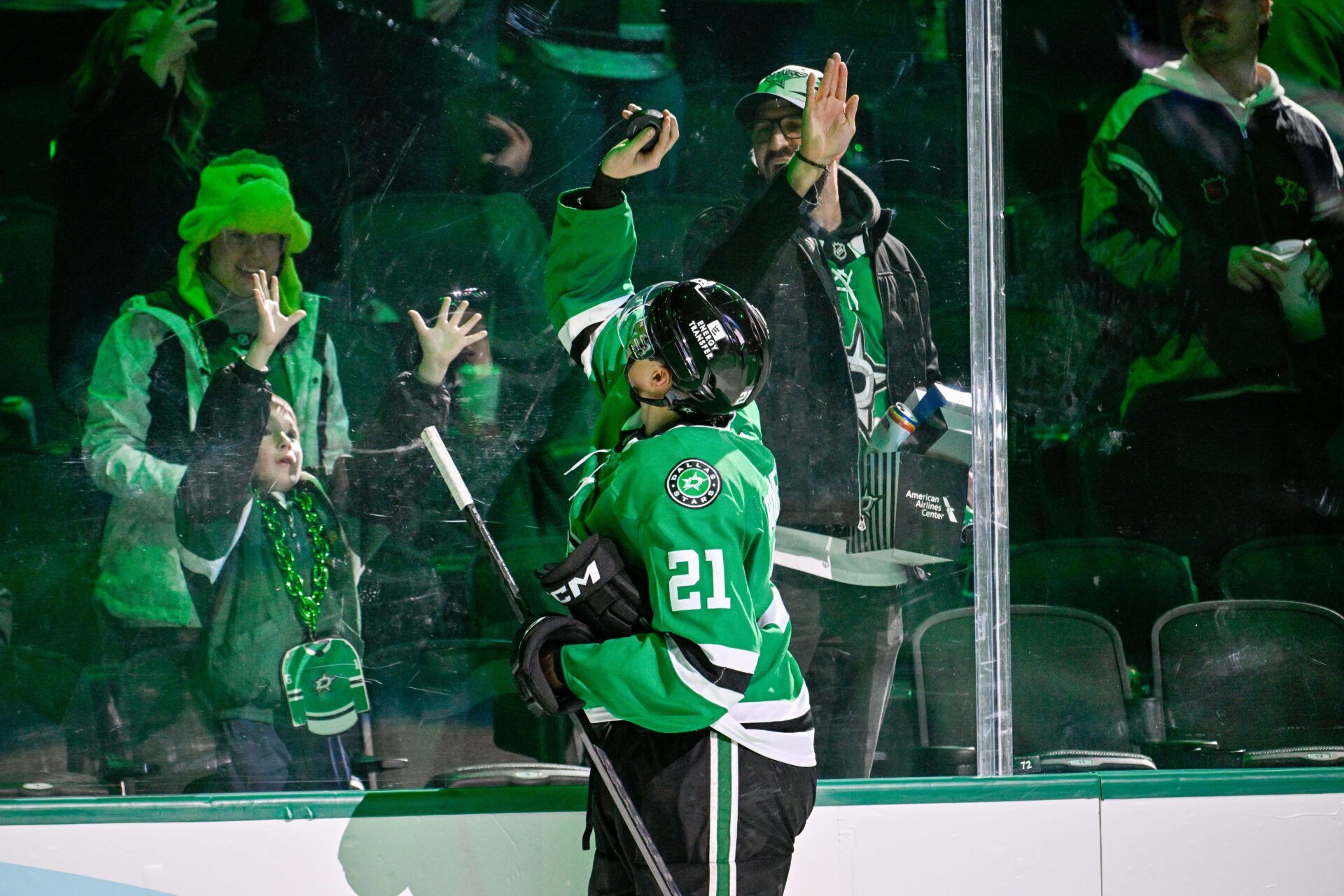 Dallas Stars left wing Jason Robertson (21) tosses a puck to a fan after the Stars victory over the St. Louis Blues at the American Airlines Center.