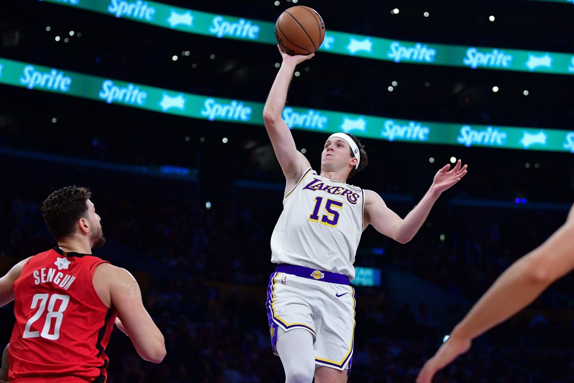Los Angeles Lakers guard Austin Reaves (15) shoots against Houston Rockets center Alperen Sengun (28) during the first half at Crypto.com Arena.