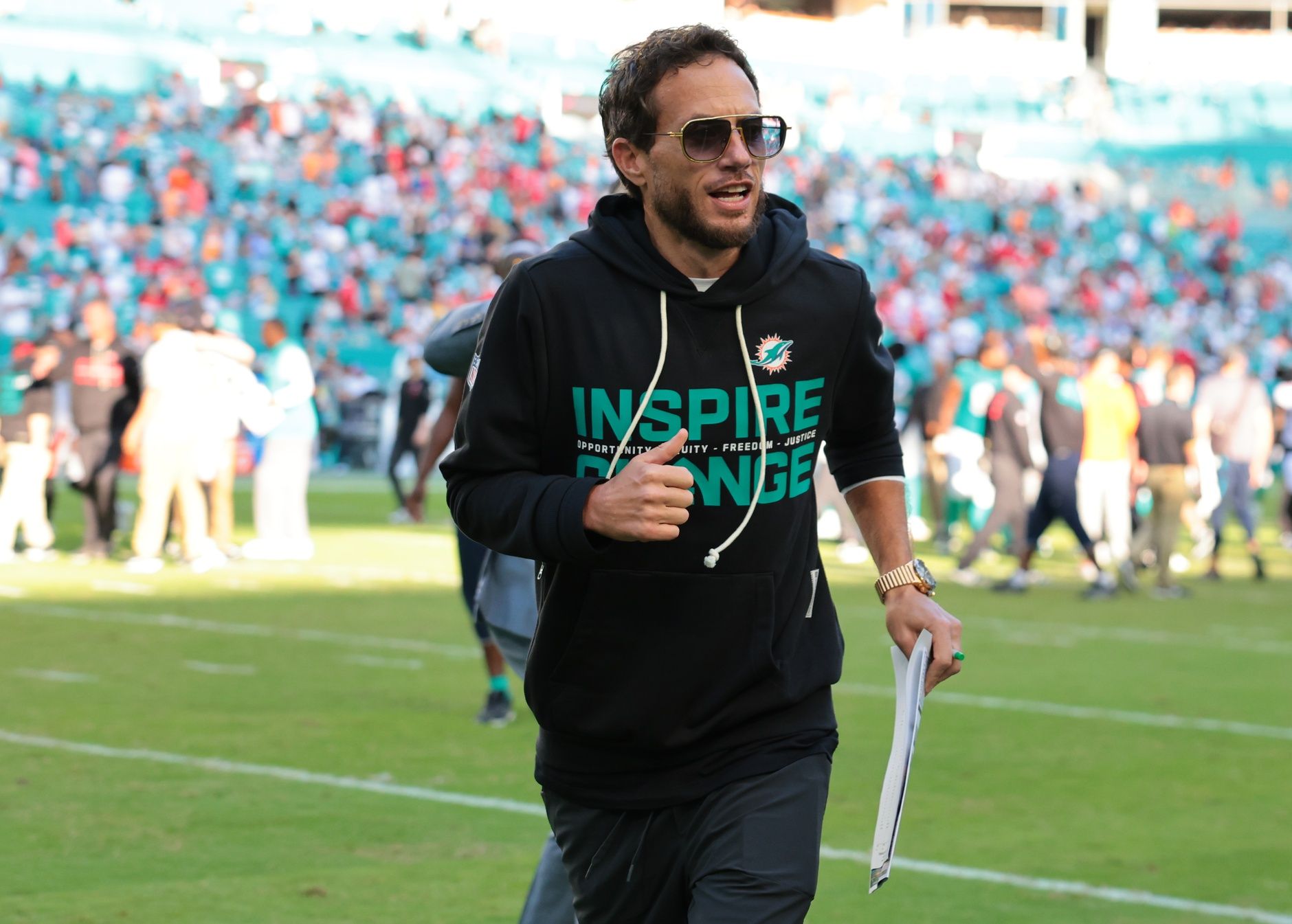 Miami Dolphins head coach Mike McDaniel runs off the field following a win over the Tampa Bay Buccaneers at Hard Rock Stadium.