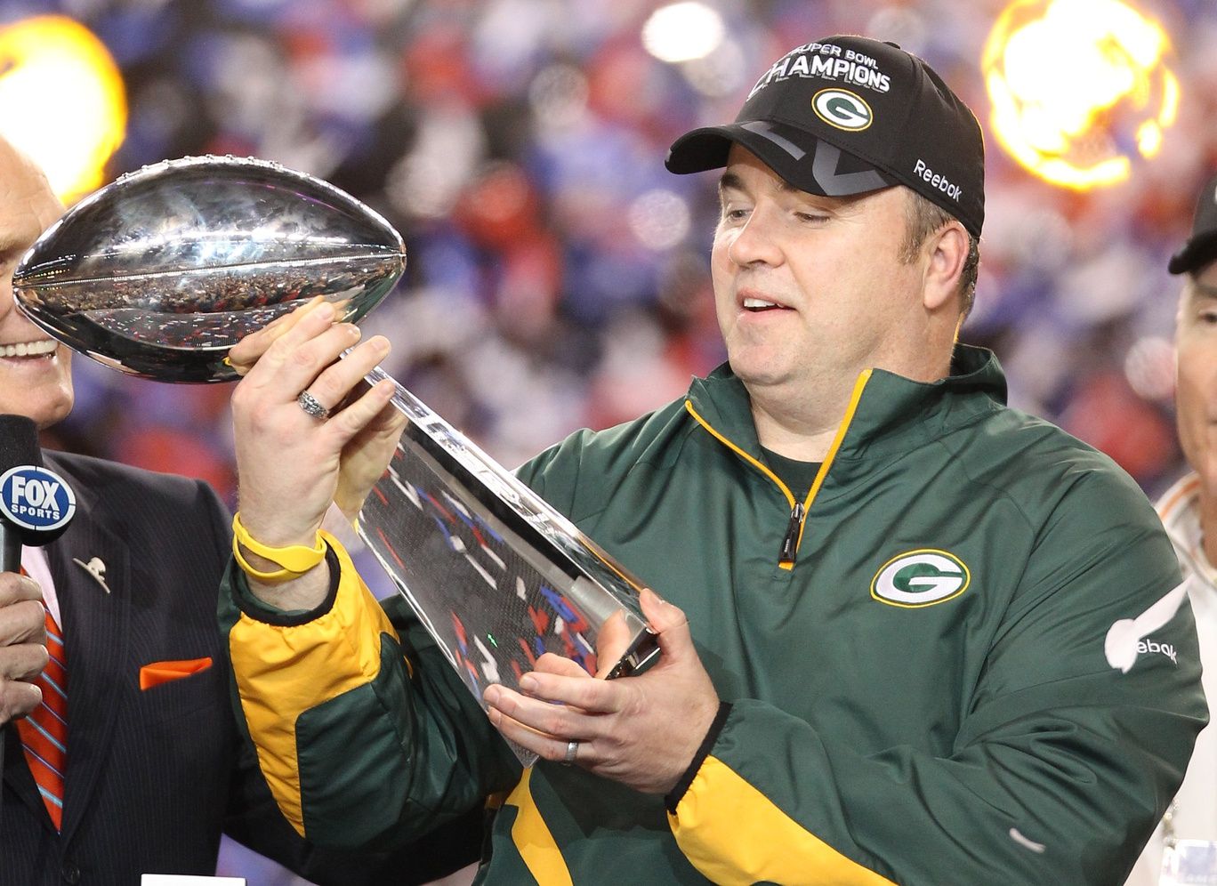 Green Bay Packers head coach Mike McCarthy hoist the Lombardi Trophy into the air following Super Bowl XLV against the Pittsburgh Steelers at Cowboys Stadium.
