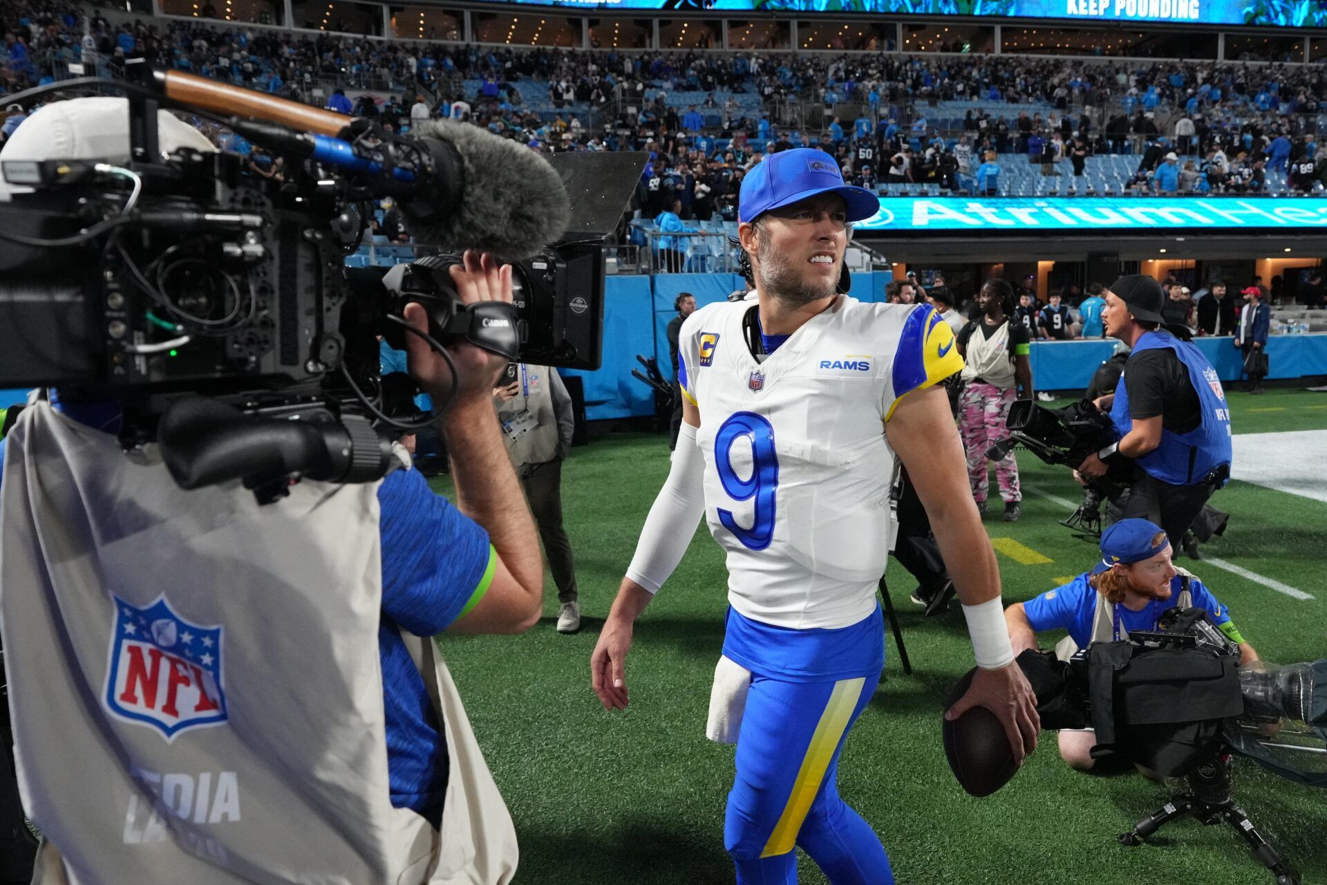 Los Angeles Rams quarterback Matthew Stafford (9) walks off the field after the NFC Wild Card Round game at Bank of America Stadium.