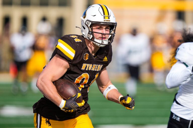 Wyoming Cowboys tight end John Michael Gyllenborg (84) scores a touchdown against the Hawaii Rainbow Warriors during the first quarter at Jonah Field at War Memorial Stadium.