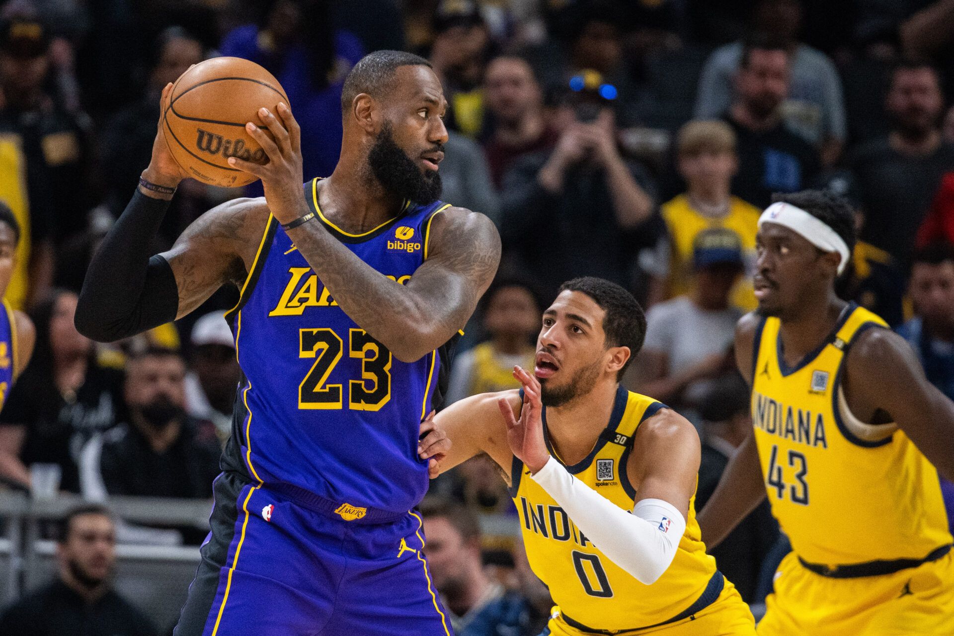 Los Angeles Lakers forward LeBron James (23) holds the ball while  Indiana Pacers guard Tyrese Haliburton (0) defends in the first half at Gainbridge Fieldhouse.