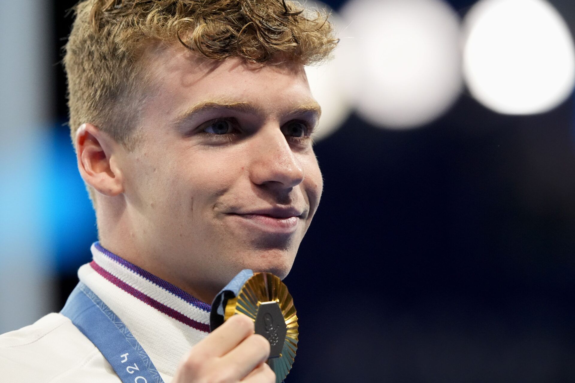 Leon Marchand (France) in the men’s 200-meter individual medley medal ceremony during the Paris 2024 Olympic Summer Games at Paris La Défense Arena.