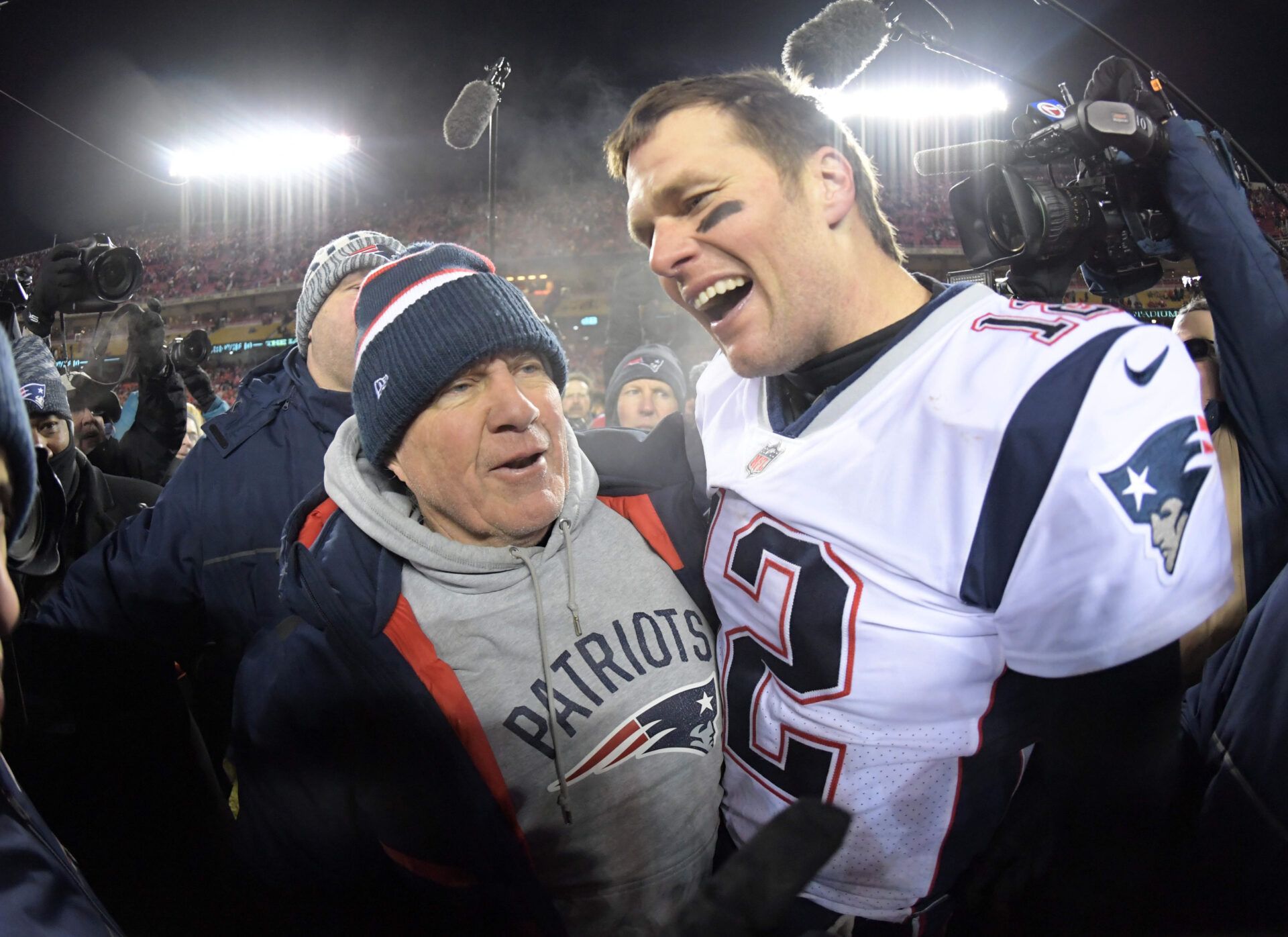 New England Patriots quarterback Tom Brady (12) celebrates with coach Bill Belichick after the AFC Championship game against the Kansas City Chiefs at Arrowhead Stadium. The Patriots defeated the Chiefs 37-31 in overtime to advance to fifth Super Bowl in eight seasons.