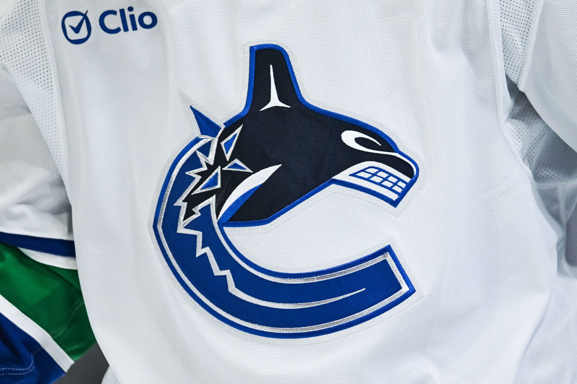 View of a Vancouver Canucks logo on a jersey worn by a member of the team at Bell Centre.