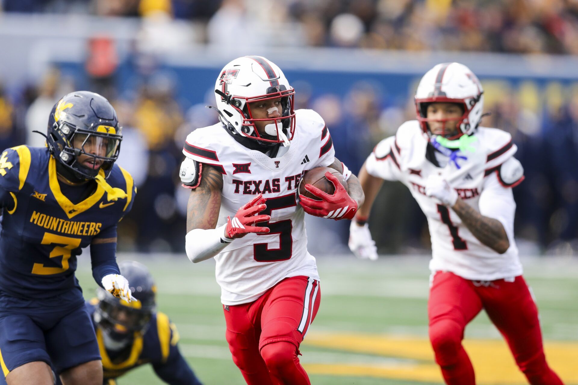 Texas Tech Red Raiders wide receiver Caleb Douglas (5) makes a catch and runs for extra yards during the second quarter against the West Virginia Mountaineers at Milan Puskar Stadium.