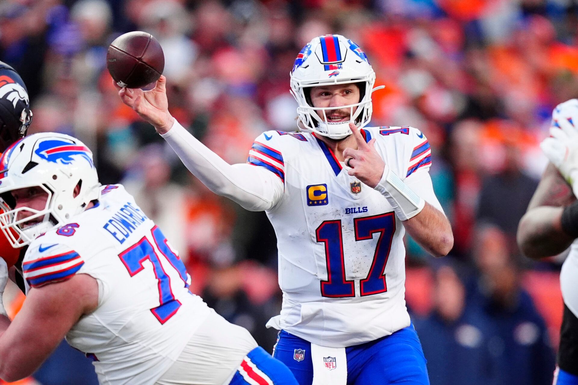 Buffalo Bills quarterback Josh Allen (17) throws a touchdown pass during the third quarter of an AFC Divisional Round playoff game against the Denver Broncos at Empower Field at Mile High.