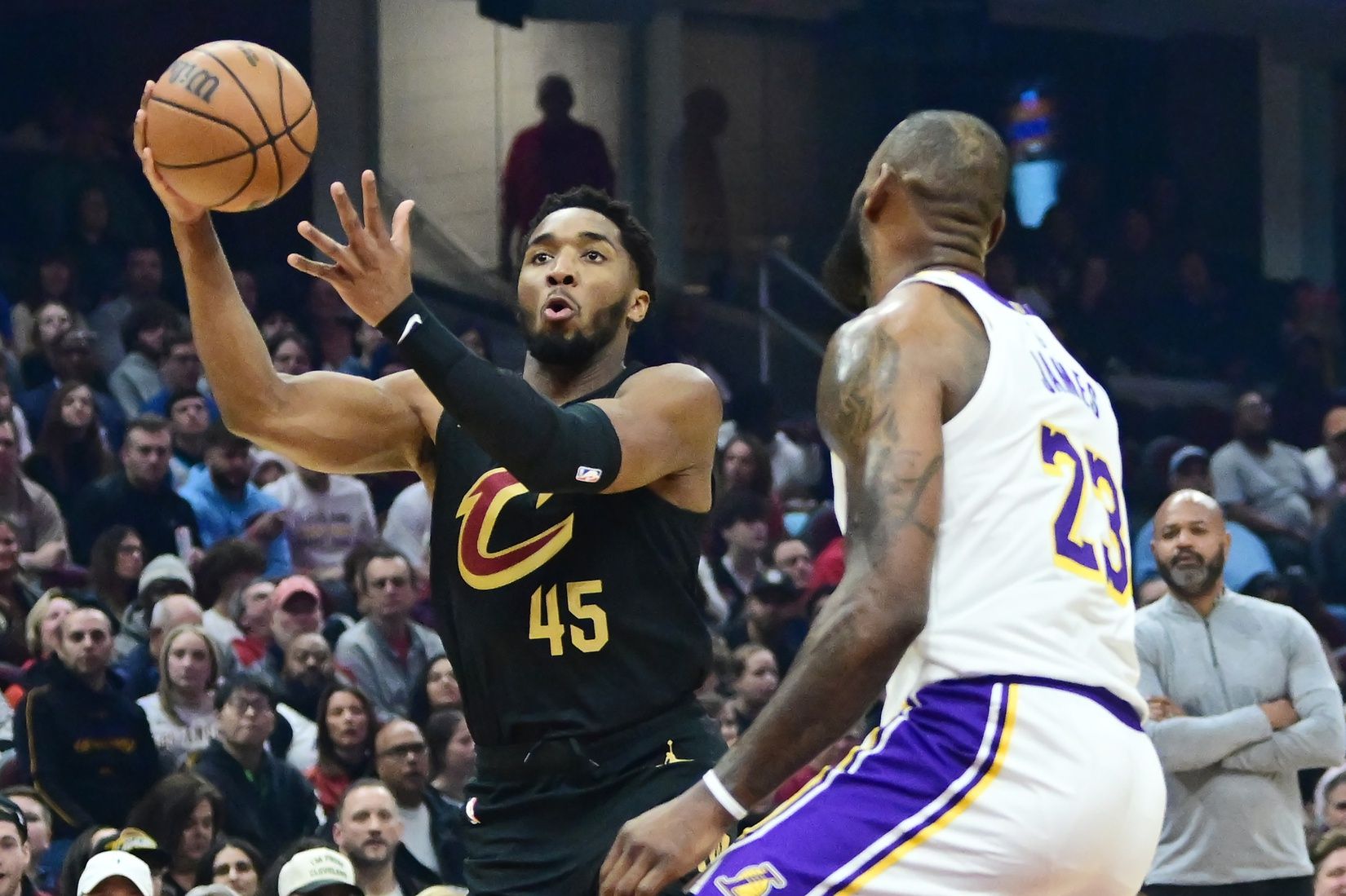 Cleveland Cavaliers guard Donovan Mitchell (45) drives to the basket against Los Angeles Lakers forward LeBron James (23) during the first half at Rocket Mortgage FieldHouse.