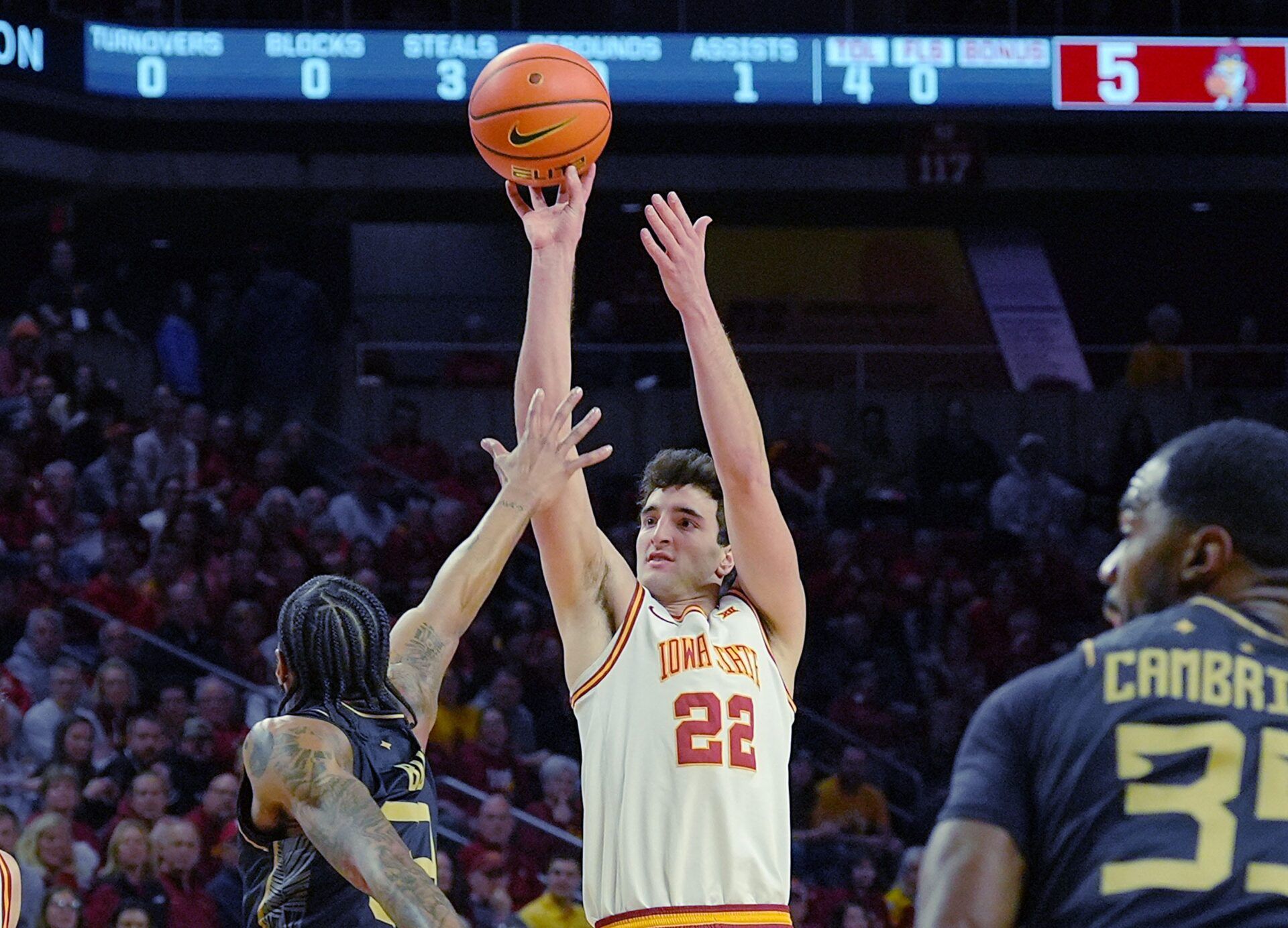 Iowa State Cyclones forward Milan Momcilovic (22) takes a three-point shot over UCF Knights forward Jordan Burks (99) during the first half in the Big-12 conference men’s basketball on Jan. 20, 2026, at Hilton Coliseum in Ames, Iowa.