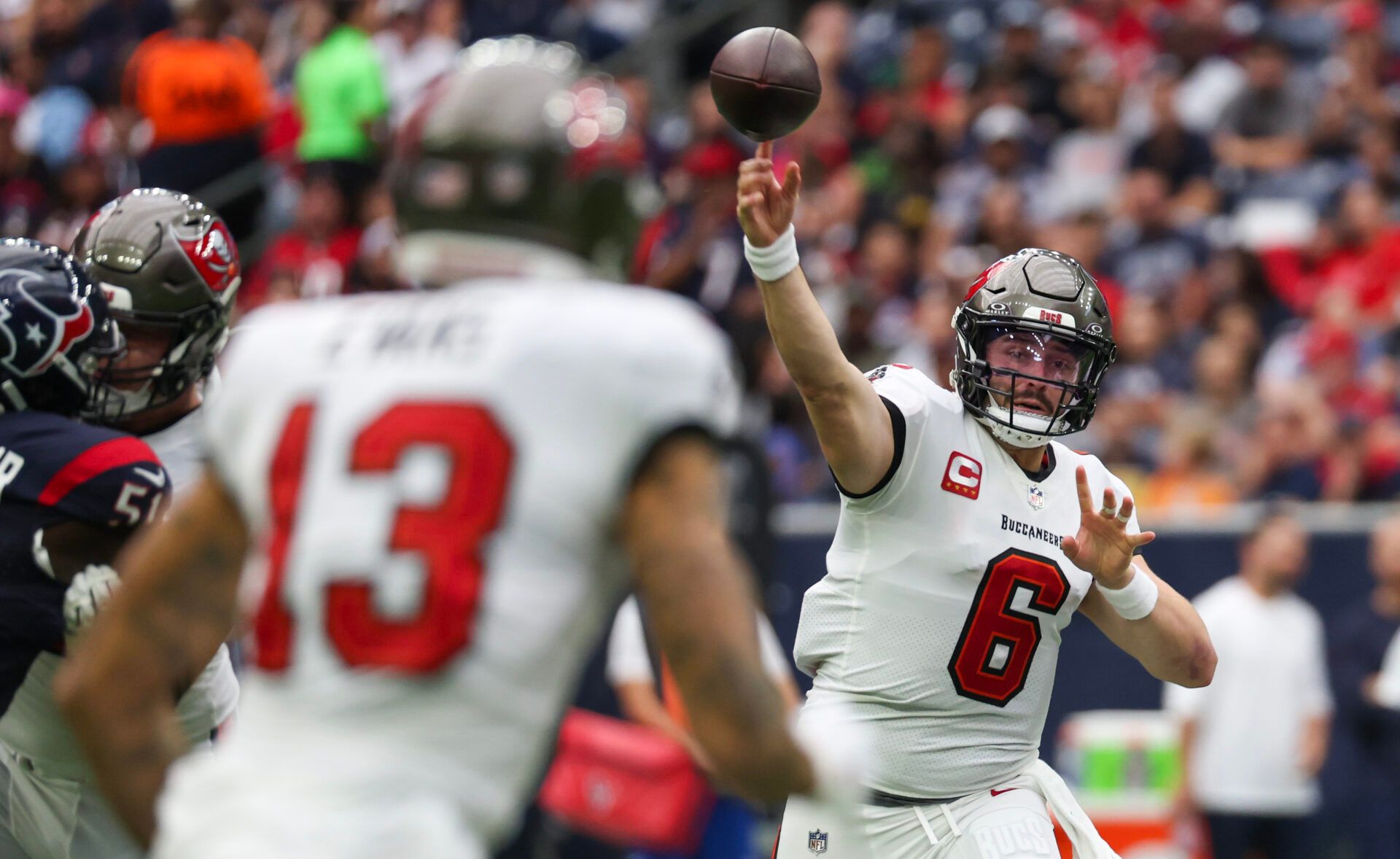 Tampa Bay Buccaneers quarterback Baker Mayfield (6) passes to wide receiver Mike Evans (13) against the Houston Texans in the first quarter at NRG Stadium.