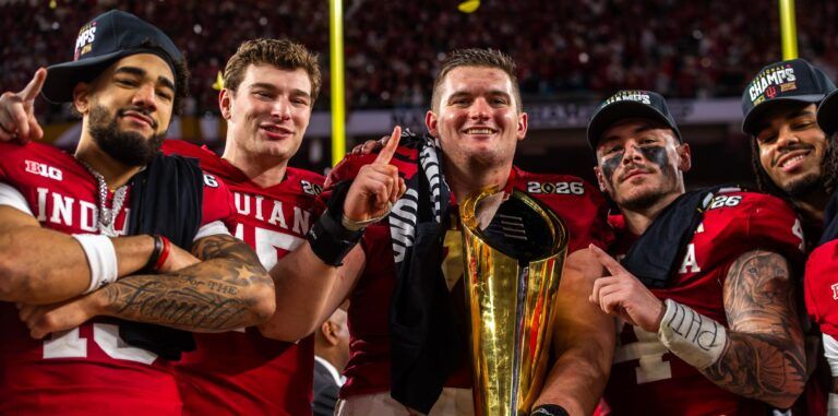 Indiana's Elijah Sarratt (13), Fernando Mendoza (15), Pat Coogan (78), Aiden Fisher (4) and Riley Nowakowski (37) pose with the trophy on the podium after the College Football Playoff National Championship college football game at Hard Rock Stadium in Miami Gardens on Monday, Jan. 19, 2026.