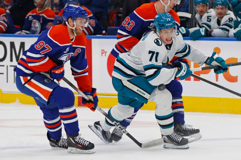 Edmonton Oilers forward Connor McDavid (97) and San Jose Sharks forward Macklin Celebrini (71) look for a loose puck during the second period at Rogers Place.