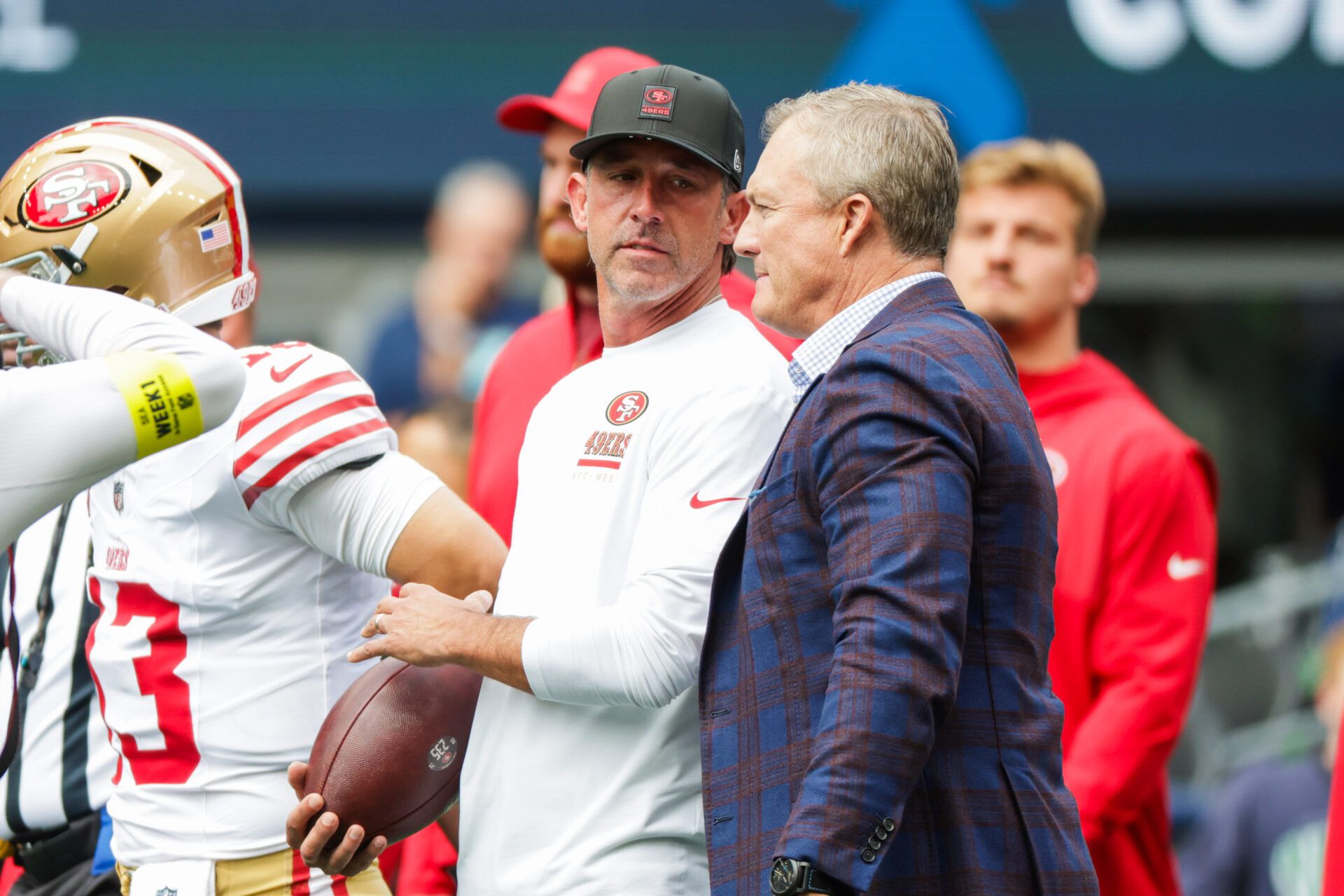 San Francisco 49ers general manager John Lynch, right, talks with head coach Kyle Shanahan during pregame warmups against the Seattle Seahawks at Lumen Field.