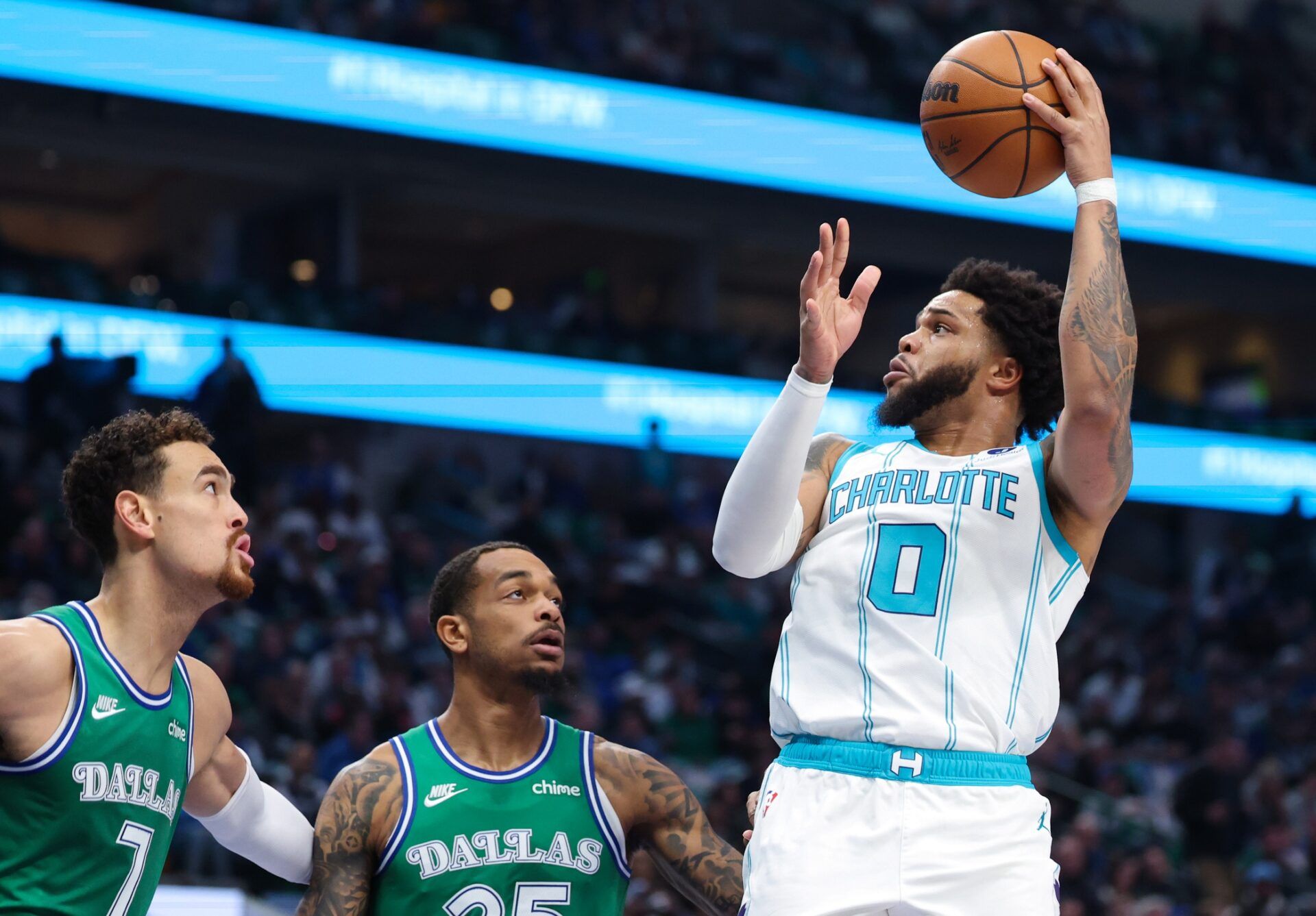 Charlotte Hornets forward Miles Bridges (0) shoots over Dallas Mavericks forward P.J. Washington (25) during the first quarter at American Airlines Center.