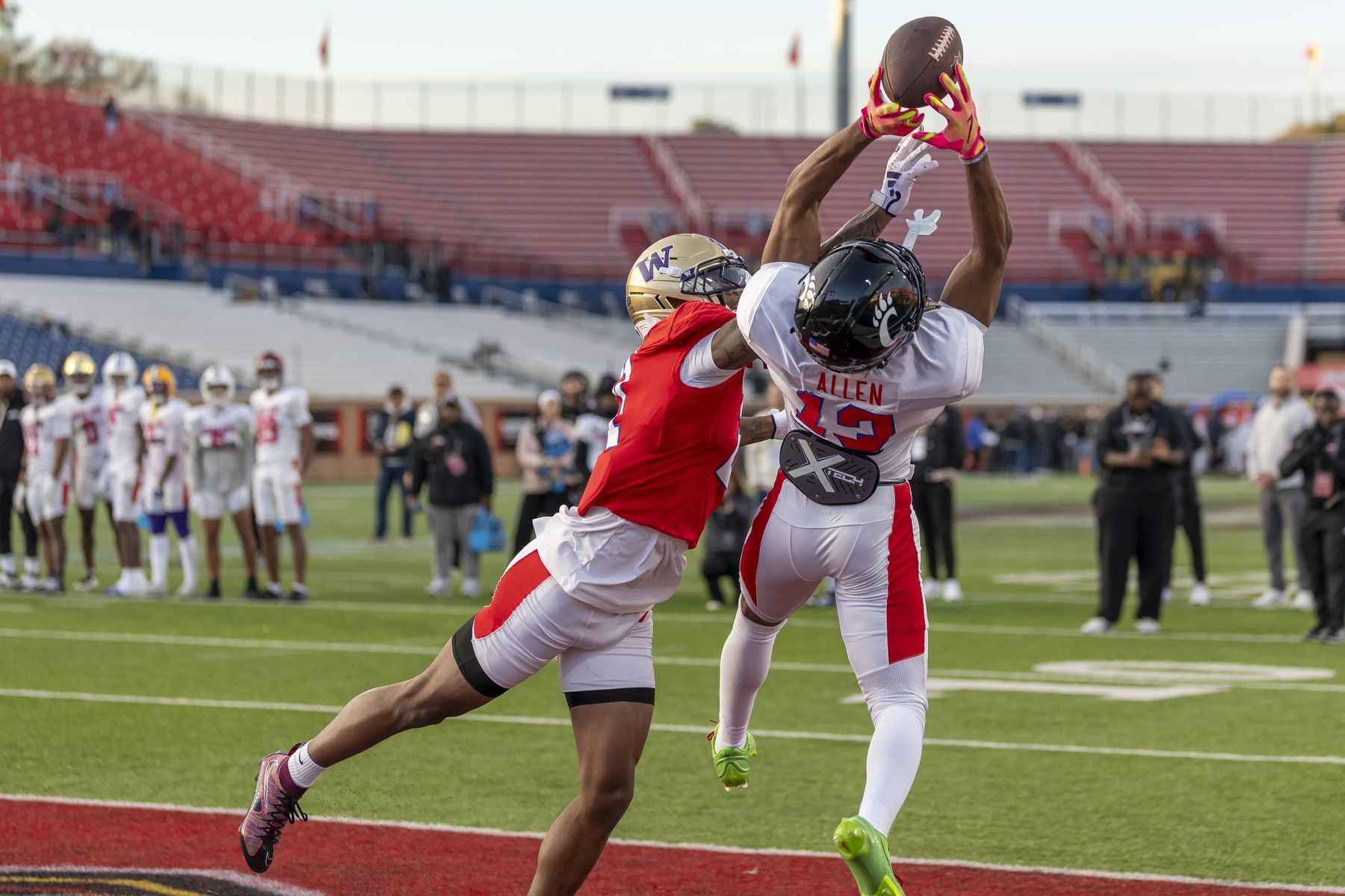 American wide receiver Cyrus Allen (13) of Cincinnati grabs a pass with American cornerback Ephesians Prysock (21) of Washington defending during American Senior Bowl practice at Hancock Whitney Stadium.