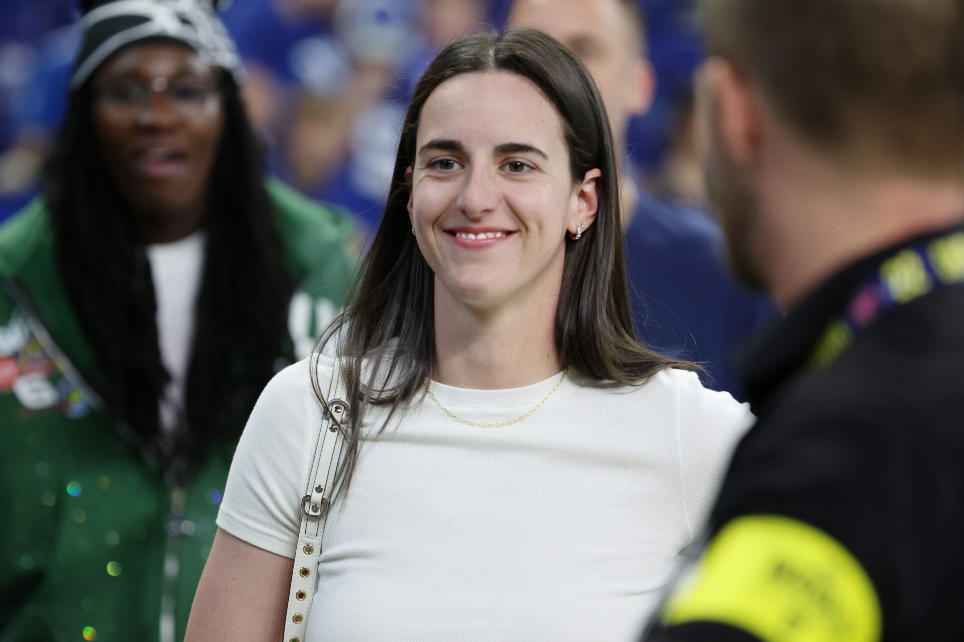 Caitlin Clark looks on from the sideline during warmups before the game between the Las Vegas Raiders and the Indianapolis Colts at Lucas Oil Stadium.