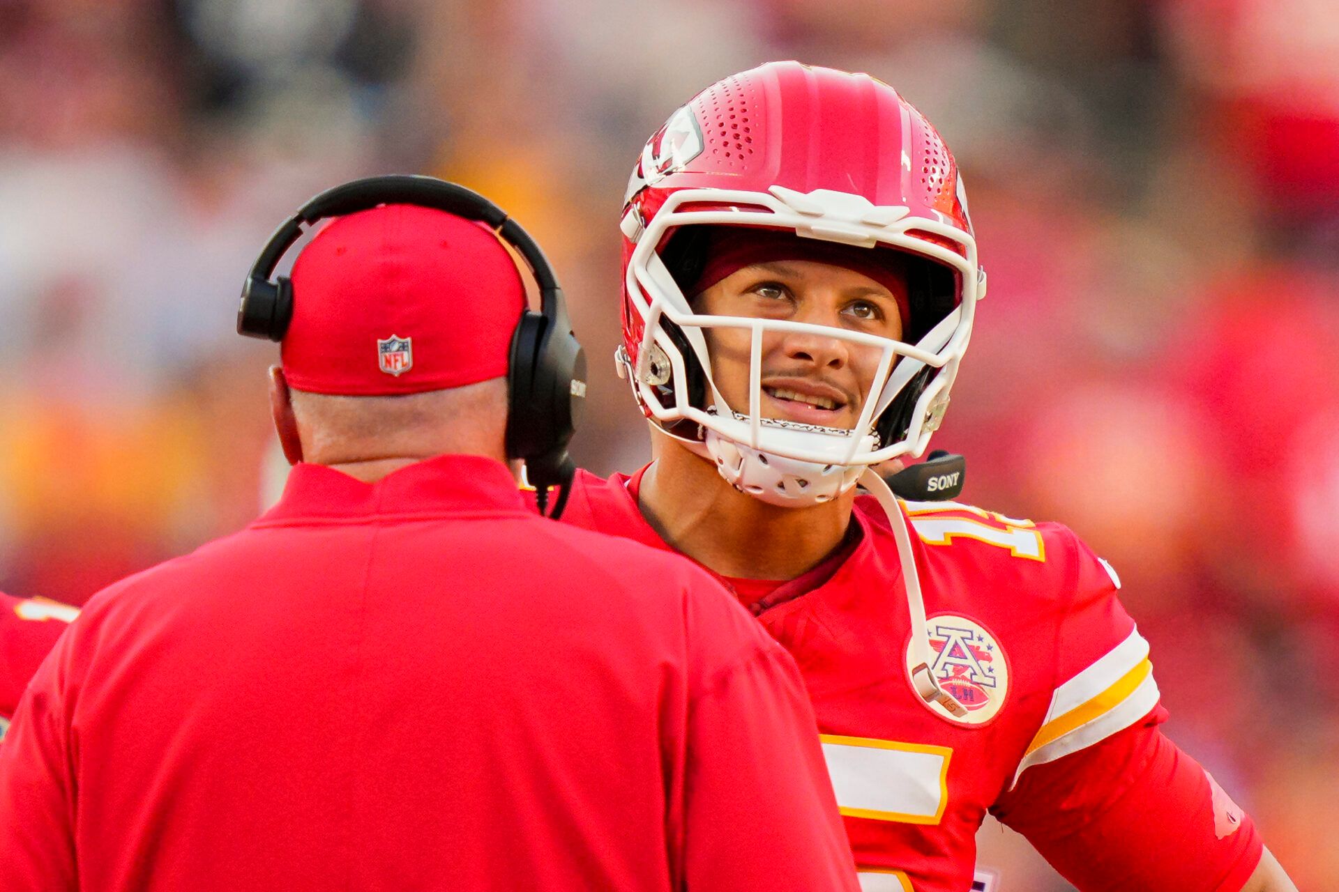 Kansas City Chiefs quarterback Patrick Mahomes (15) talks with head coach Andy Reid during the second half against the Baltimore Ravens at GEHA Field at Arrowhead Stadium.