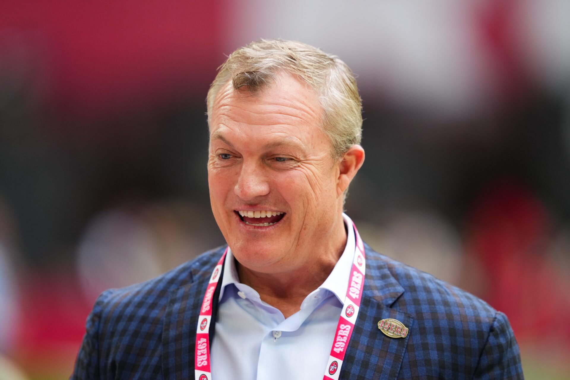 San Francisco 49ers general manager John Lynch speaks on the sidelines before the game against the Arizona Cardinals at State Farm Stadium.