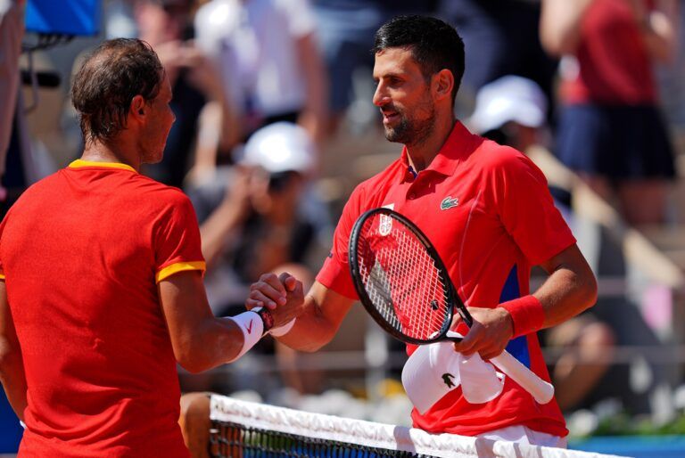 Novak Djokovic (SRB) shakes hands with Rafael Nadal (ESP) after their match in the men’s tennis sinlges first round during the Paris 2024 Olympic Summer Games at Stade Roland Garros.