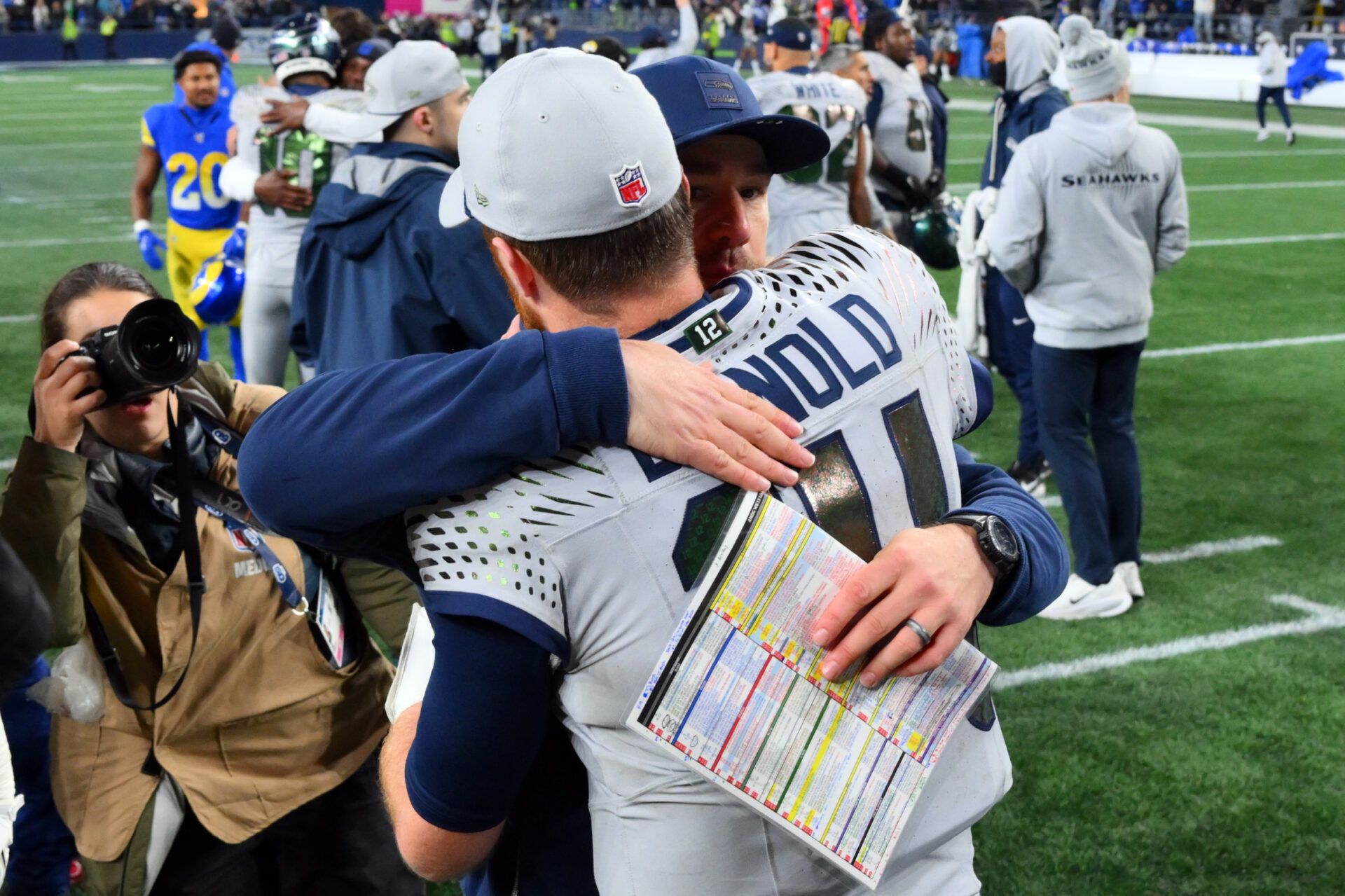 Seattle Seahawks quarterback Sam Darnold (14) hugs offensive coordinator Klint Kubiak after defeating the Los Angeles Rams in overtime at Lumen Field.