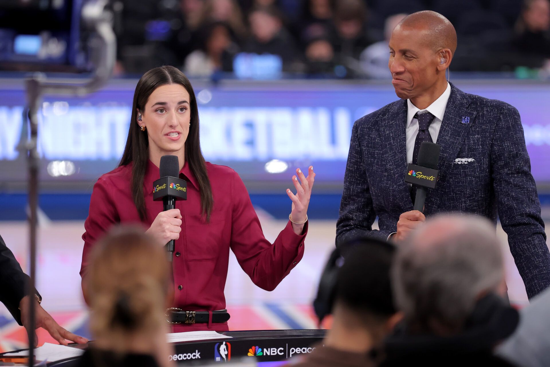 WNBA star Caitlin Clark (left) and NBA former player Reggie Miller broadcast on the court for NBC before a game between the New York Knicks and the Los Angeles Lakers at Madison Square Garden.