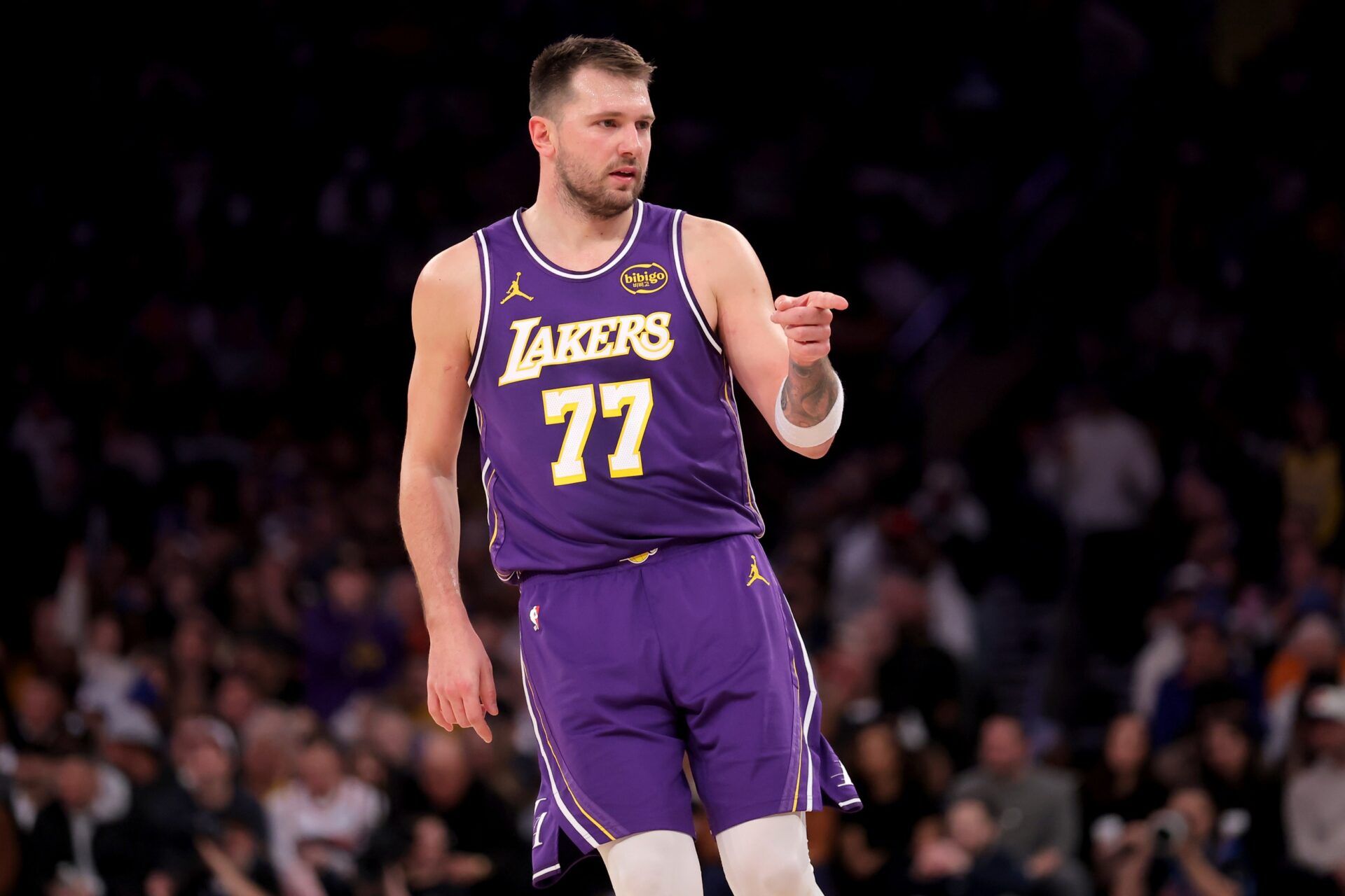 Los Angeles Lakers guard Luka Doncic (77) points in the direction of Knicks fan Spike Lee (not pictured) after a three point shot against the New York Knicks during the third quarter at Madison Square Garden.
