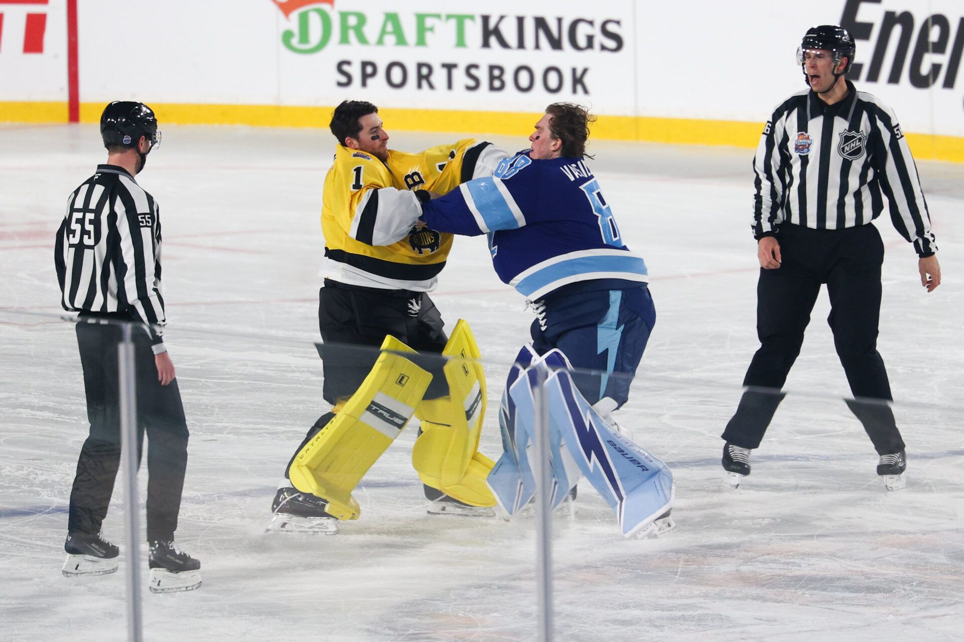 Boston Bruins goaltender Jeremy Swayman (1) and Tampa Bay Lightning goaltender Andrei Vasilevskiy (88) exchange punches as officials Kyle Flemington and Julien Fournier look on during the second period in the 2026 Stadium Series ice hockey game at Raymond James Stadium.