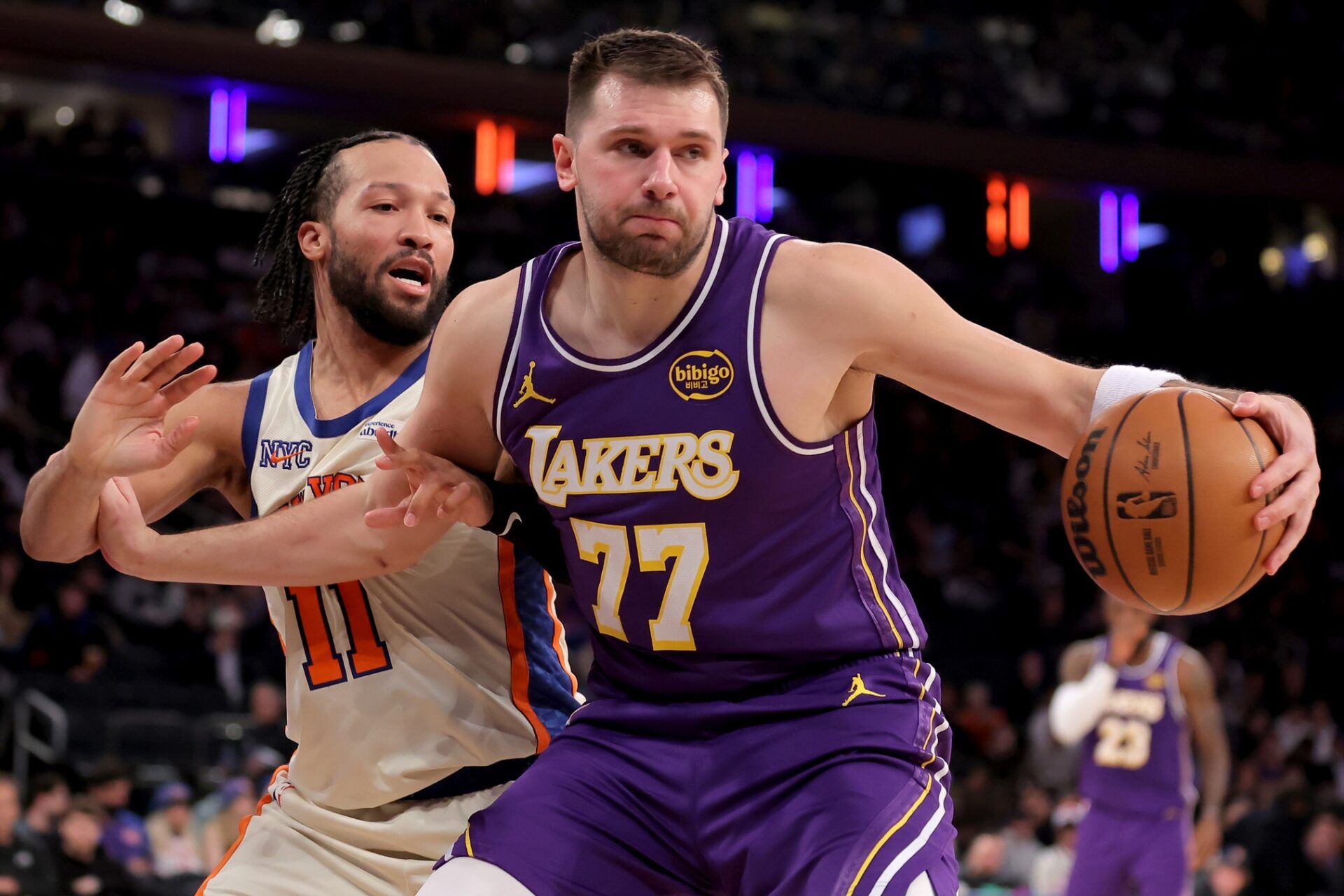 Los Angeles Lakers guard Luka Doncic (77) controls the ball against New York Knicks guard Jalen Brunson (11) during the third quarter at Madison Square Garden.