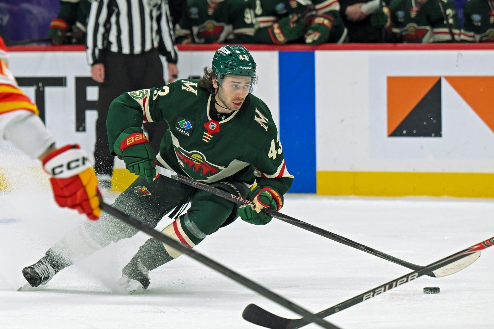 Minnesota Wild defensemen Quinn Hughes (43) controls the puck against the Calgary Flames during the second period at Grand Casino Arena.