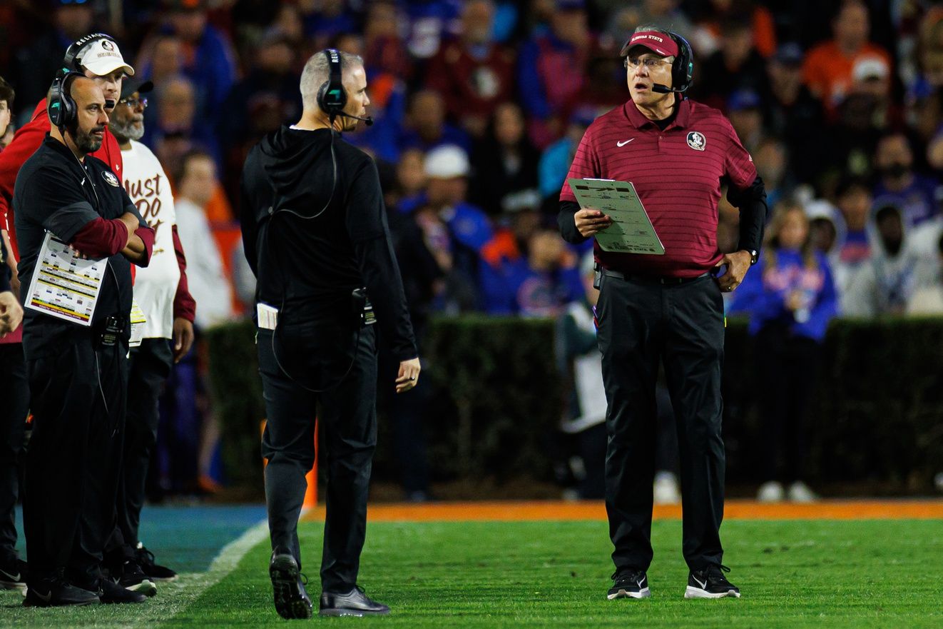 Florida State Seminoles head coach Mike Norvell and Florida State Seminoles offensive coordinator Gus Malzahn talk against the Florida Gators during the second half at Ben Hill Griffin Stadium.