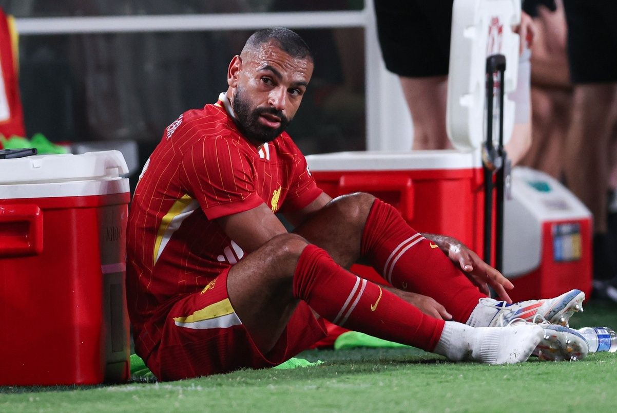 Liverpool forward Mohamed Salah (11) removes his cleats after being subbed out during the second half against Arsenal at Lincoln Financial Field.