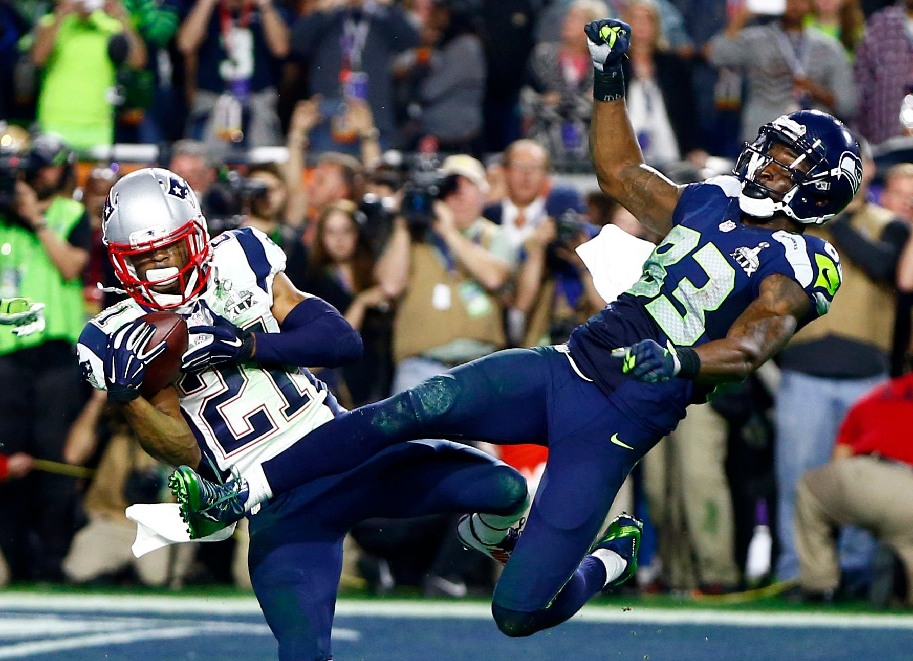 New England Patriots strong safety Malcolm Butler (21) intercepts a pass intended for Seattle Seahawks wide receiver Ricardo Lockette (83) in the fourth quarter in Super Bowl XLIX at University of Phoenix Stadium.