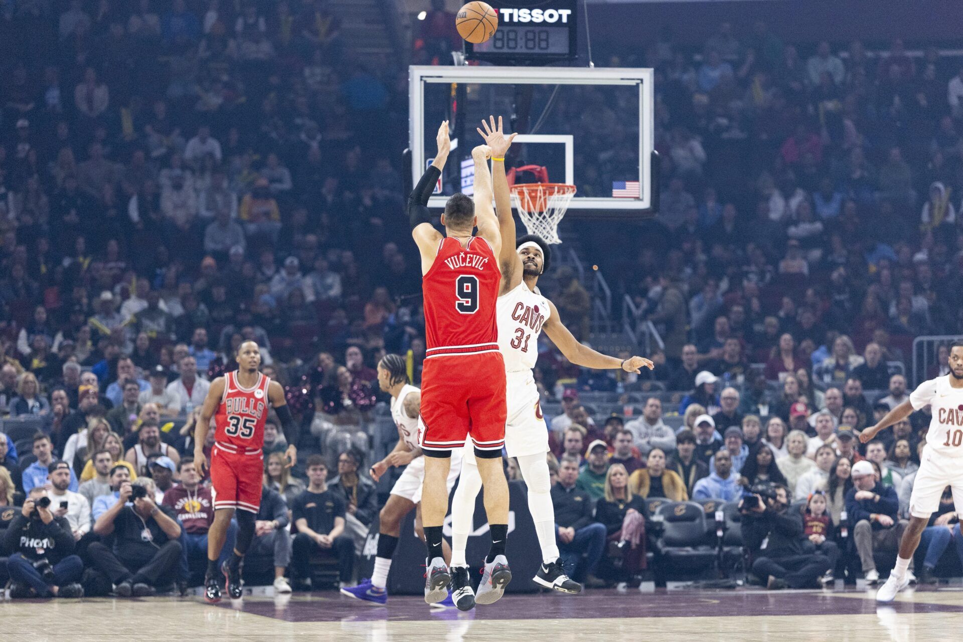 Chicago Bulls center Nikola Vučević (9) takes a three-point shot over Cleveland Cavaliers center Jarrett Allen (31) during the first quarter at Rocket Arena.