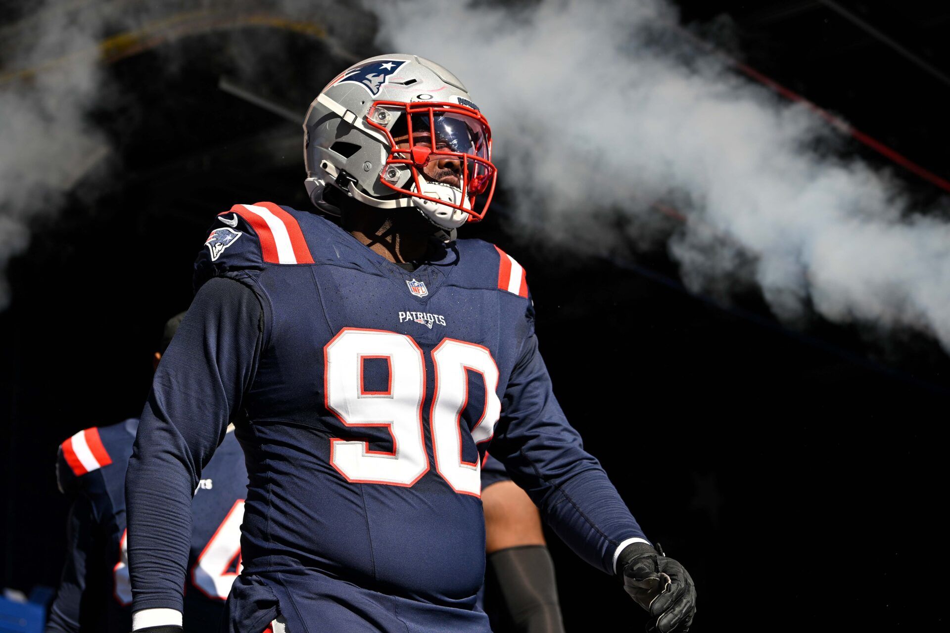 New England Patriots defensive tackle Christian Barmore (90) walks out of the tunnel before a game against the Atlanta Falcons at Gillette Stadium.