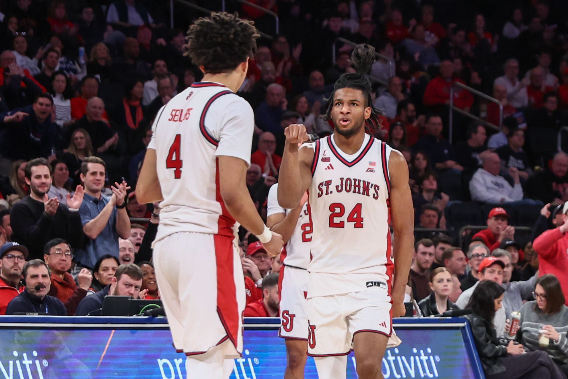 St. John's Red Storm forward Zuby Ejiofor (24) celebrates with guard Oziyah Sellers (4) in the second half against the Butler Bulldogs at Madison Square Garden.