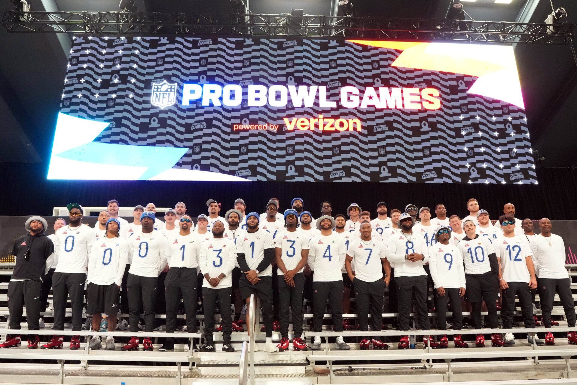 NFC players and coaches pose for team photo at the Flag Fieldhouse Moscone Center South Building.