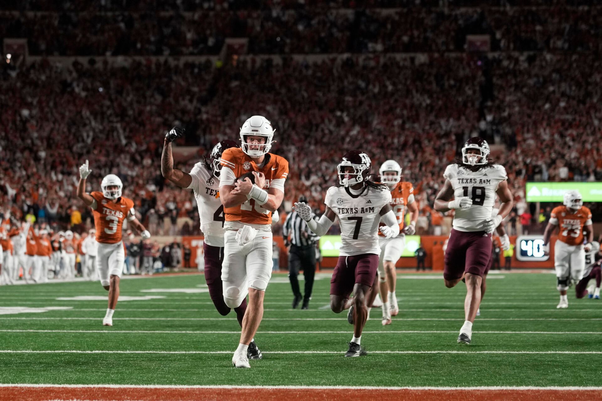Texas Longhorns quarterback Arch Manning keeps the ball and runs for a touchdown during the second half against the Texas A&M Aggies at Darrell K Royal-Texas Memorial Stadium.