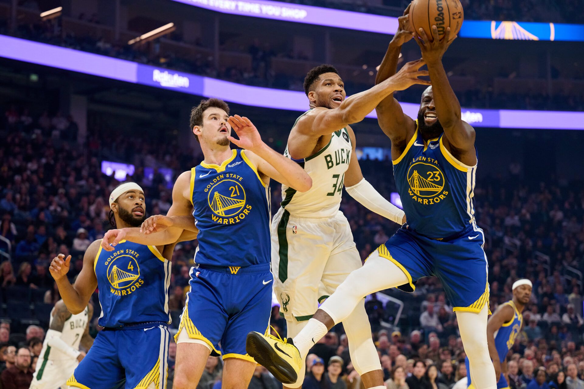 Milwaukee Bucks forward Giannis Antetokounmpo (34) vies for a rebound against Golden State Warriors forward Draymond Green (23), center Quinten Post (21) and guard Moses Moody (4) during the first quarter at Chase Center.