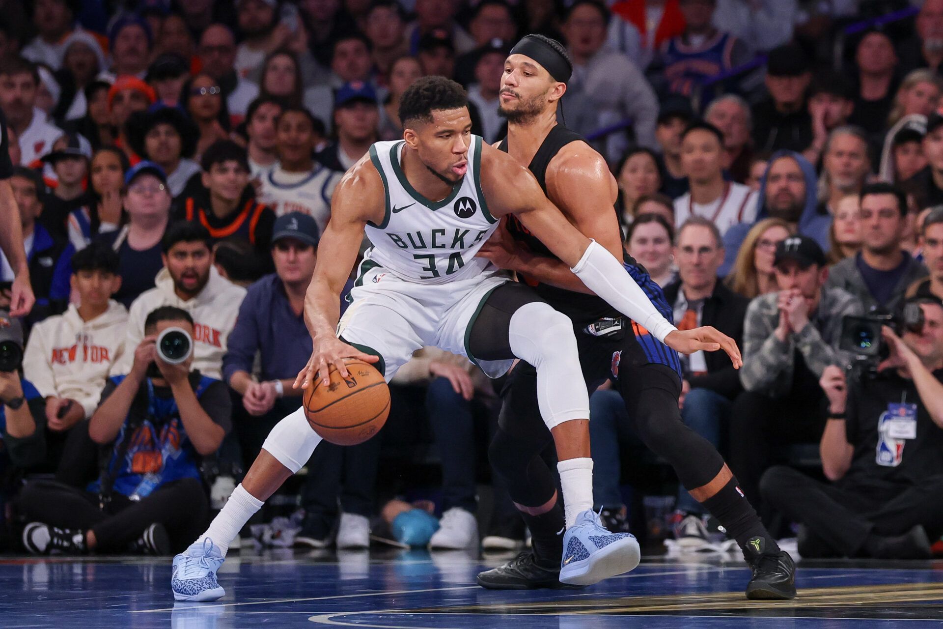 Milwaukee Bucks forward Giannis Antetokounmpo (34) dribbles as New York Knicks guard Josh Hart (3) defends during the second half at Madison Square Garden.