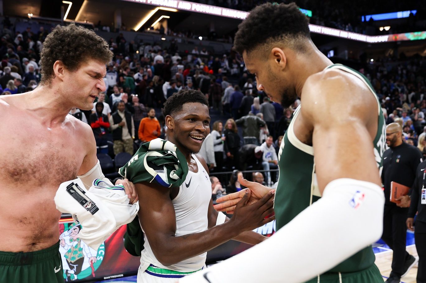 Minnesota Timberwolves guard Anthony Edwards (5) and Milwaukee Bucks forward Giannis Antetokounmpo (34) shake hands after the game at Target Center.