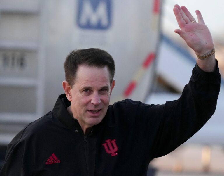 Indiana head coach Curt Cignetti waves to media members as his team returns home after beating Miami in the College Football Playoff national championship game on Tuesday, Jan. 20, 2026, in Indianapolis.