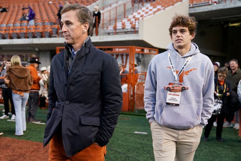 Texas Longhorns quarterback recruit Arch Manning with his father Cooper Manning on the sidelines before the game against the Texas Christian Horned Frogs at Darrell K Royal-Texas Memorial Stadium.