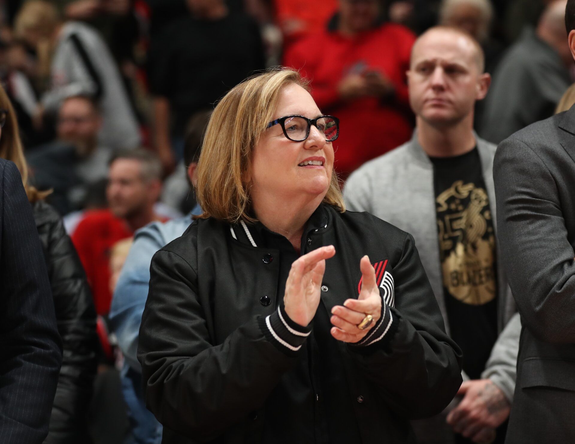 Portland Trail Blazers Chair Jody Allen applauds team before they play in the home-opener against the Denver Nuggets at Moda Center.