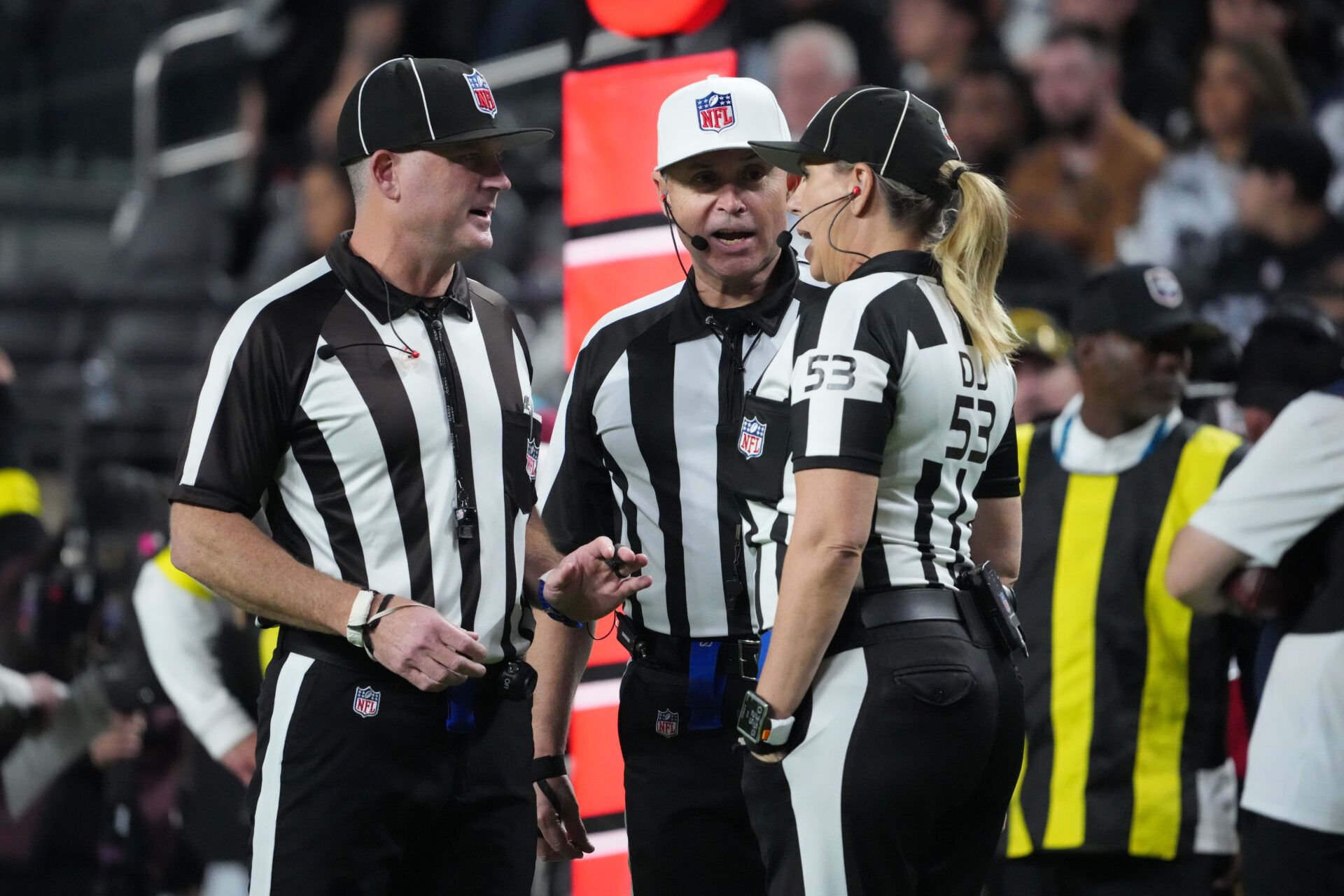 Side judge Chad Hill (125), referee Brad Allen (122) and down judge Sarah Thomas (53) talk between plays during the second half of a game between the Las Vegas Raiders and the Dallas Cowboys  at Allegiant Stadium.