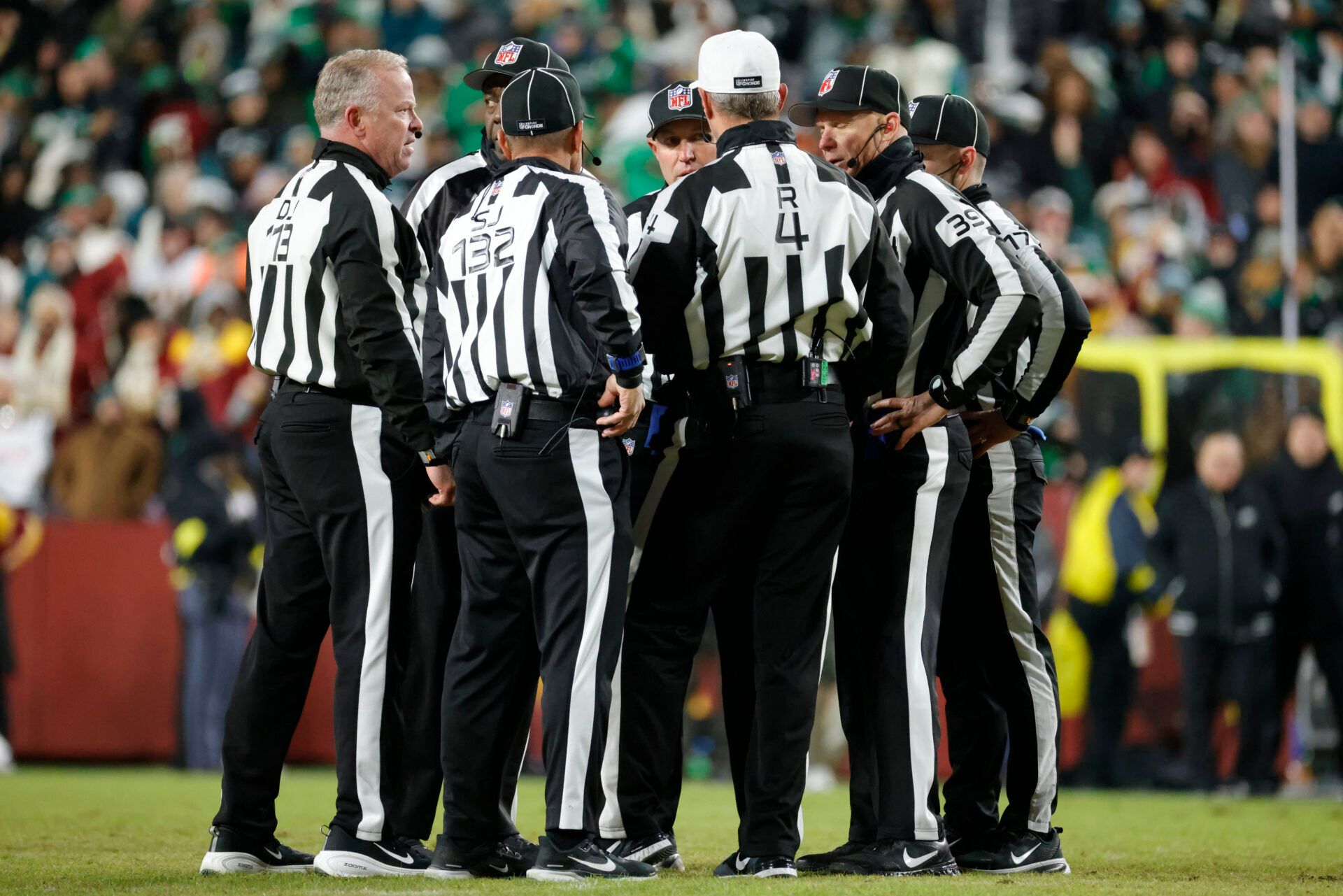 Referees talk on the field after a fight between the Washington Commanders and the Philadelphia Eagles during the second half at Northwest Stadium.