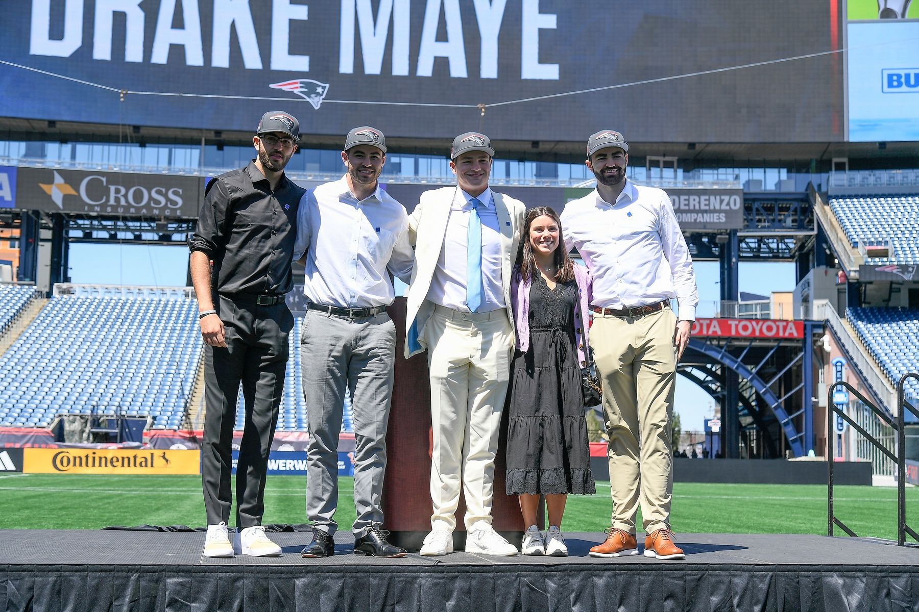 New England Patriots number one draft pick quarterback Drake Maye (C) introduces (L-R: Beau, Cole, Luke) and his girlfriend since 7th grade (Ann Michael) on the game field at Gillette Stadium.