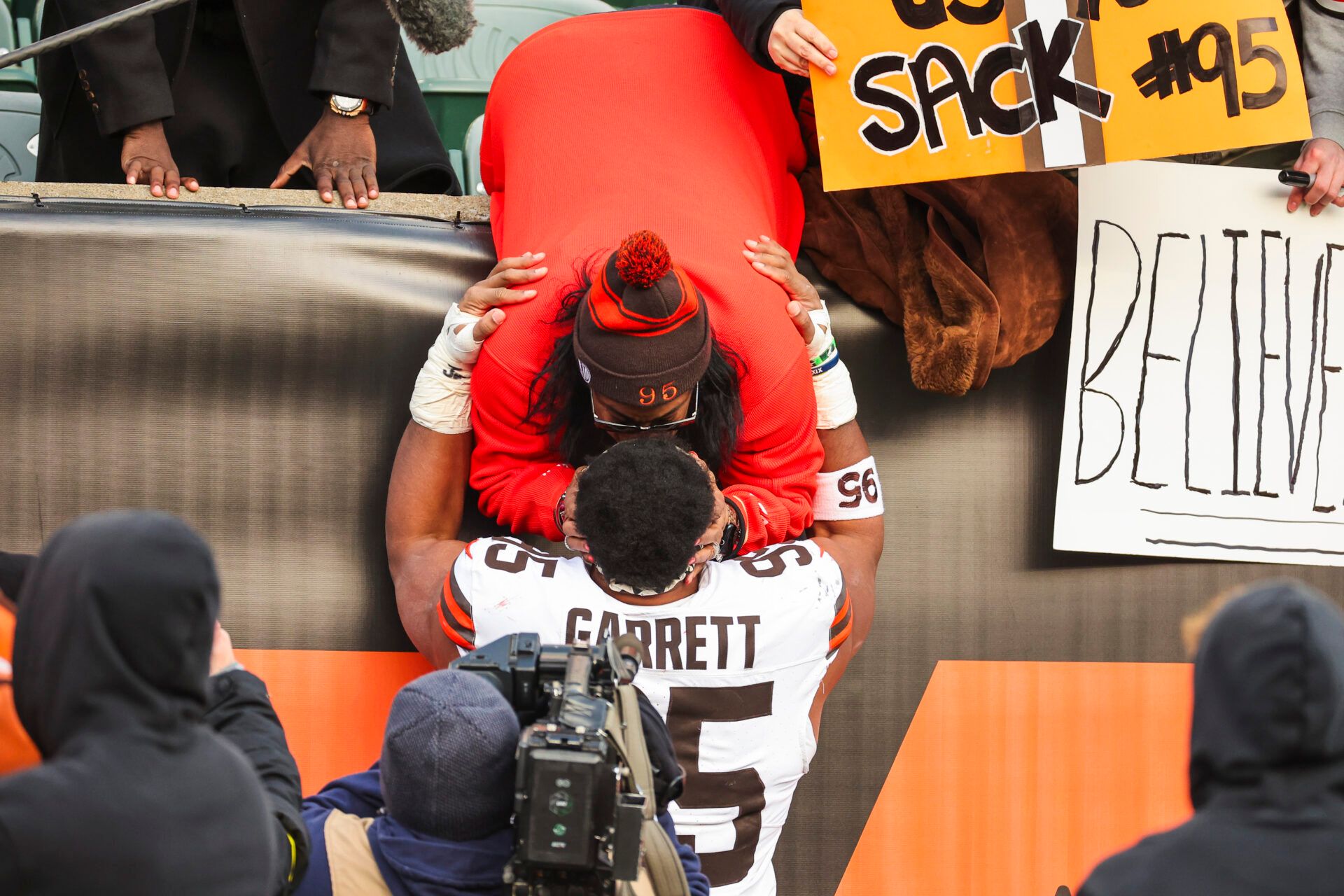 Cleveland Browns defensive end Myles Garrett (95) greets family following a victory against the Cincinnati Bengals at Paycor Stadium.