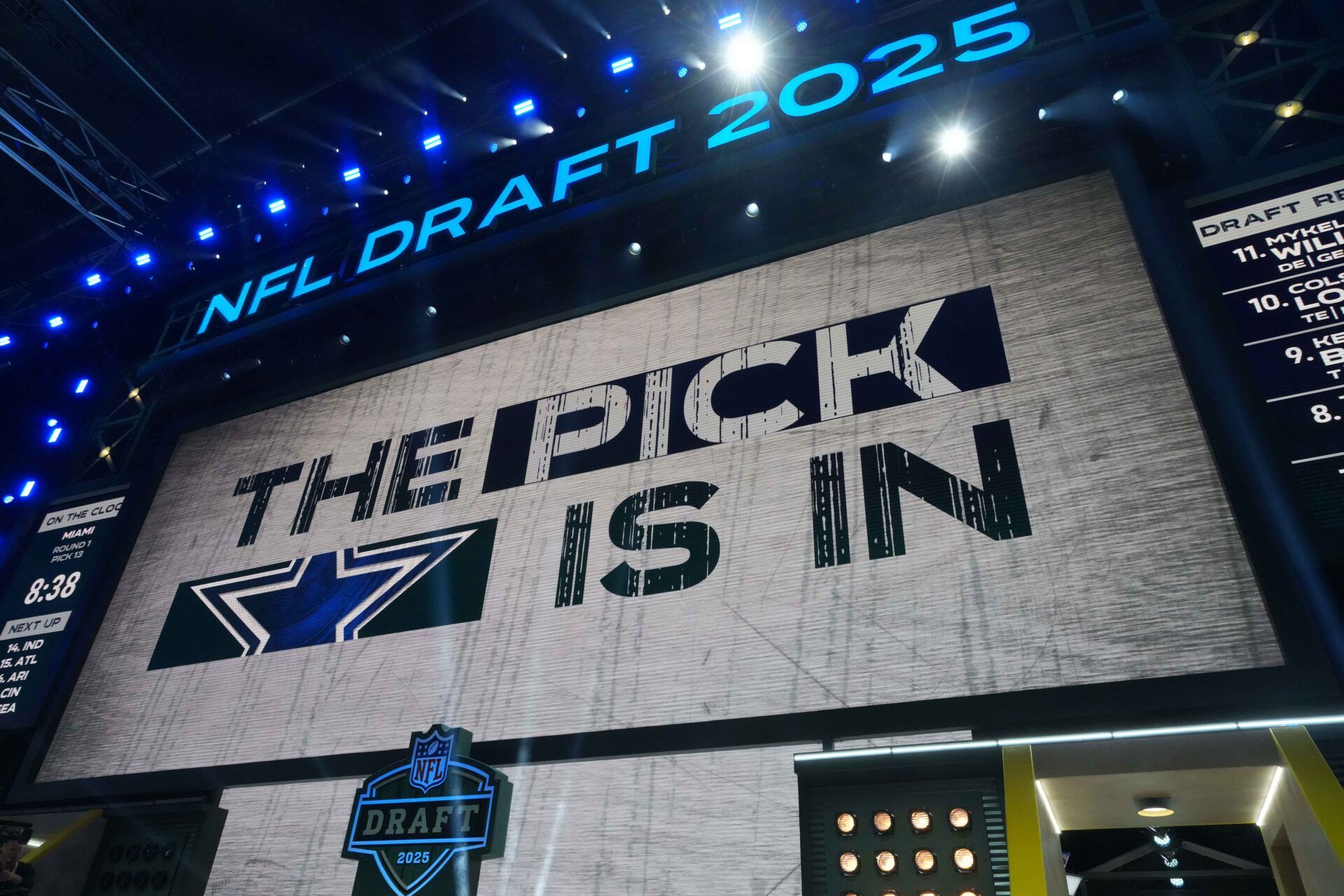 The Dallas Cowboys logo is projected on the video board during the NFL Draft at Lambeau Field.